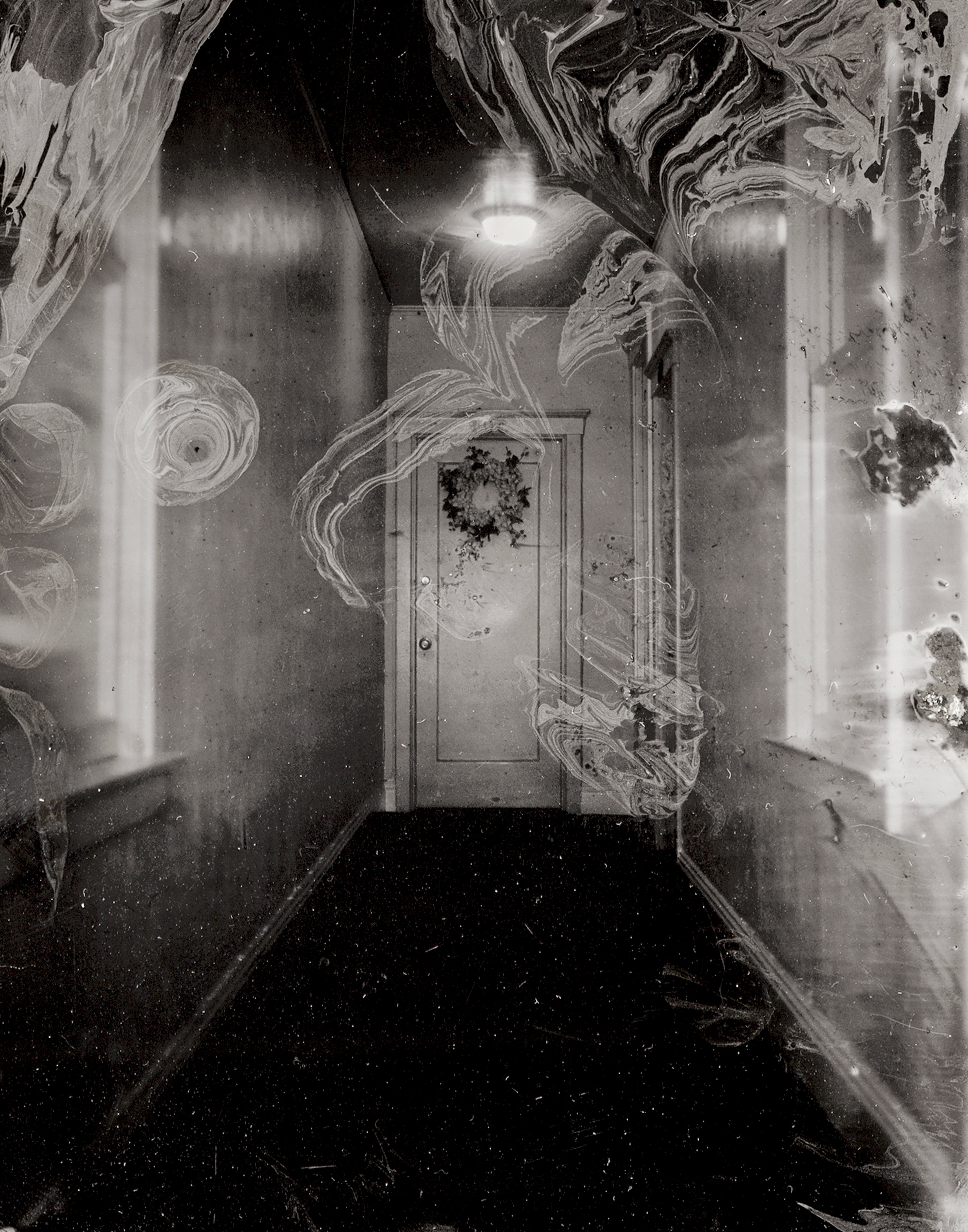 Haunting interior collodion photograph featuring ornate wallpapered walls with swirling patterns, tall windows casting dramatic light and shadows through ethereal film grain
