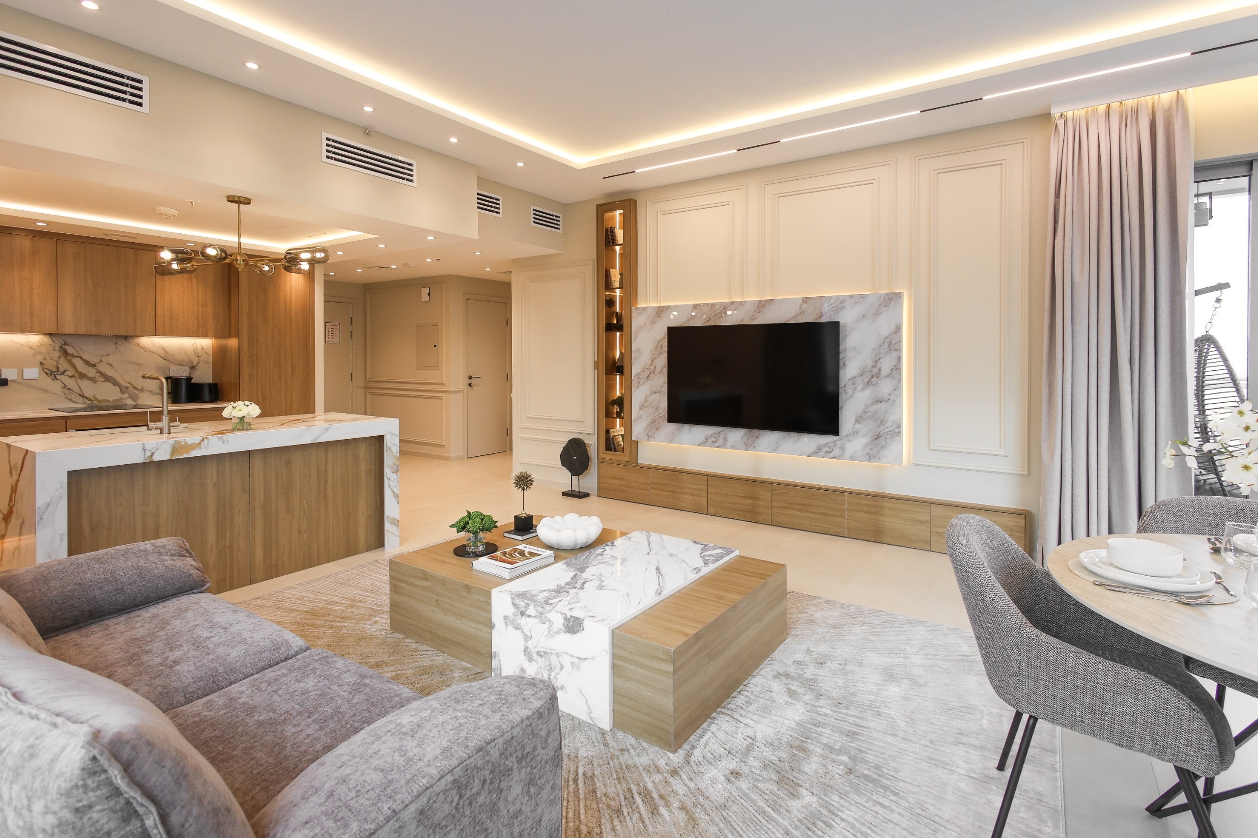 Open plan living room with marble TV wall