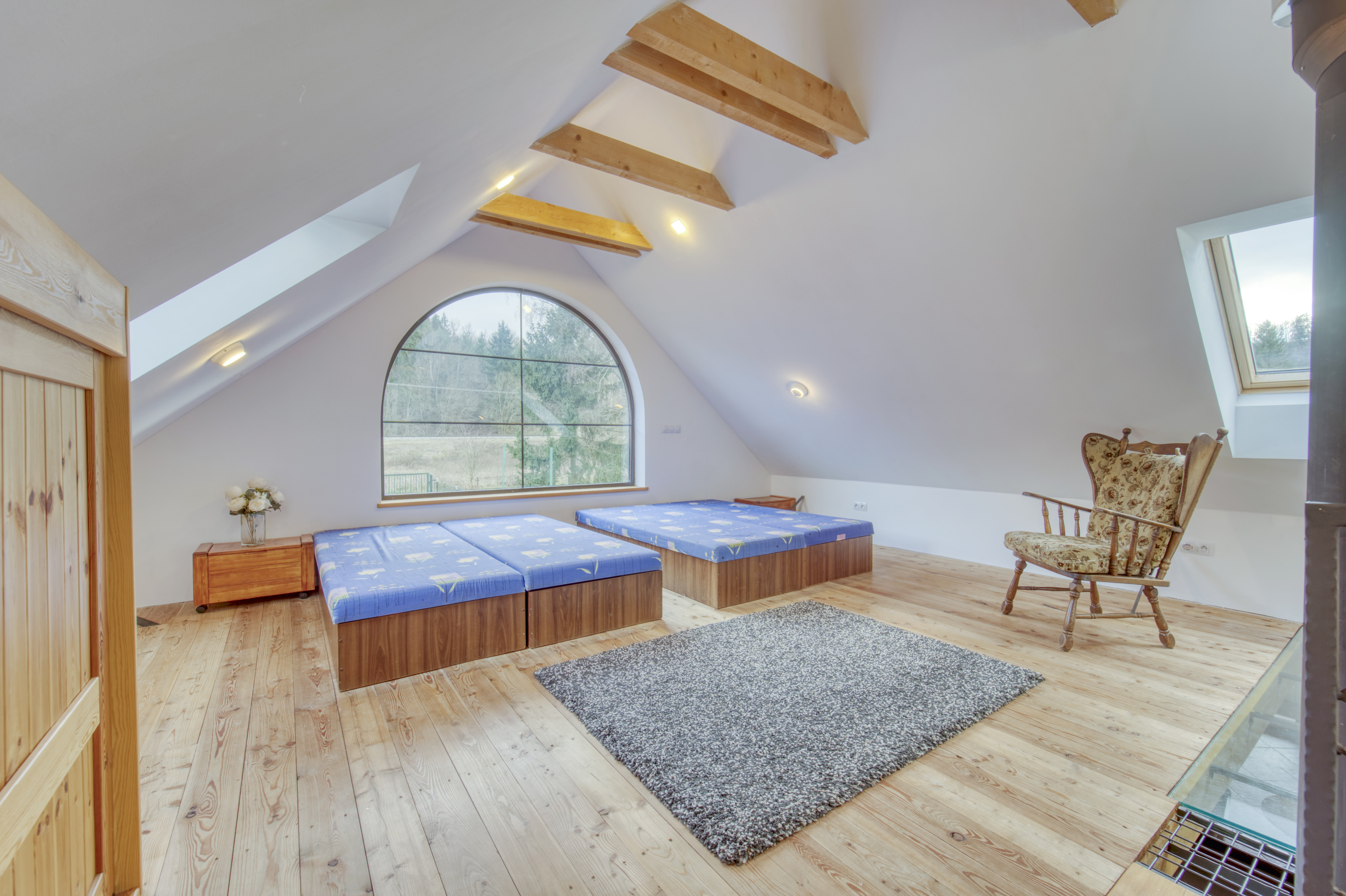 Attic bedroom with skylights and arched window