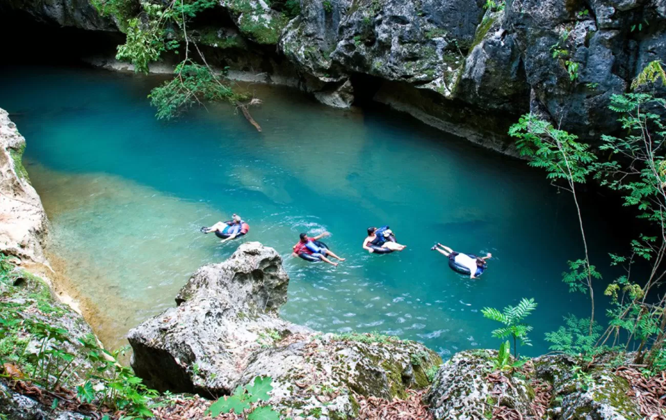 Cave tubing adventure through crystal-clear waters in Belize's limestone caves