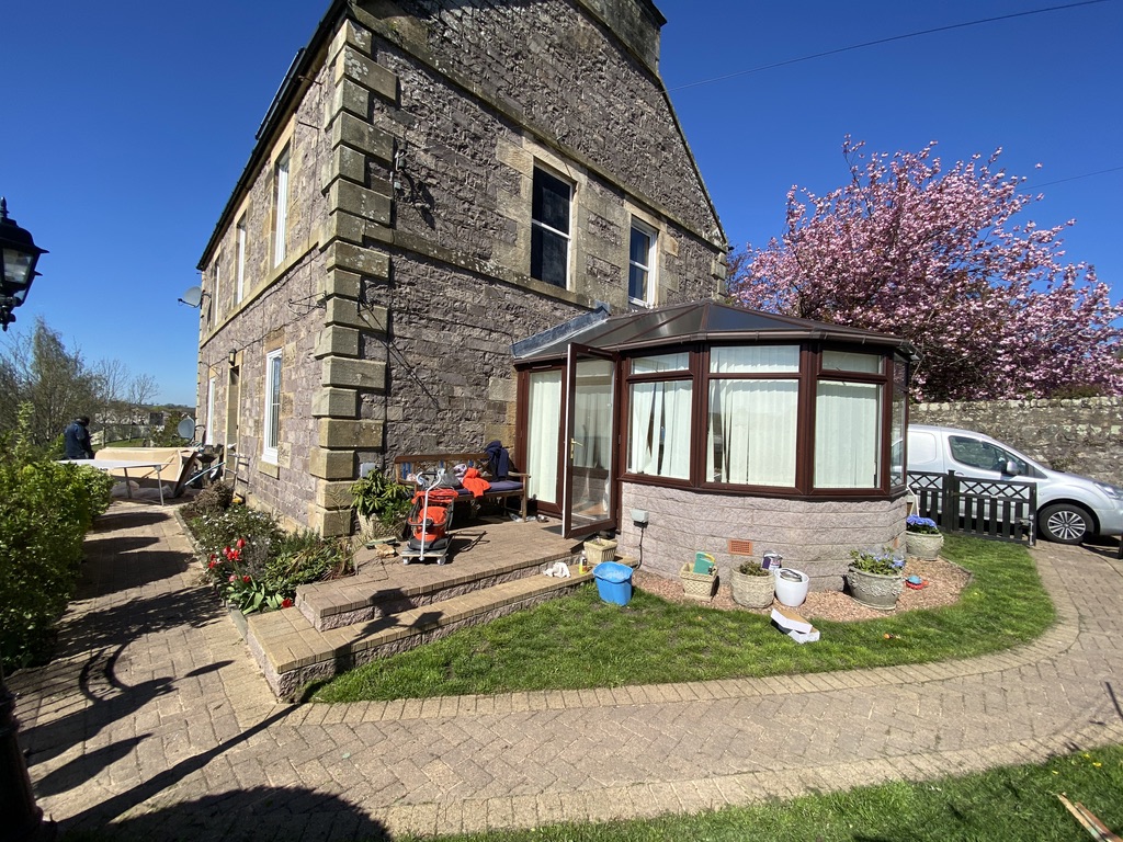 Renovated stone property with cherry blossom and pristine paved walkways