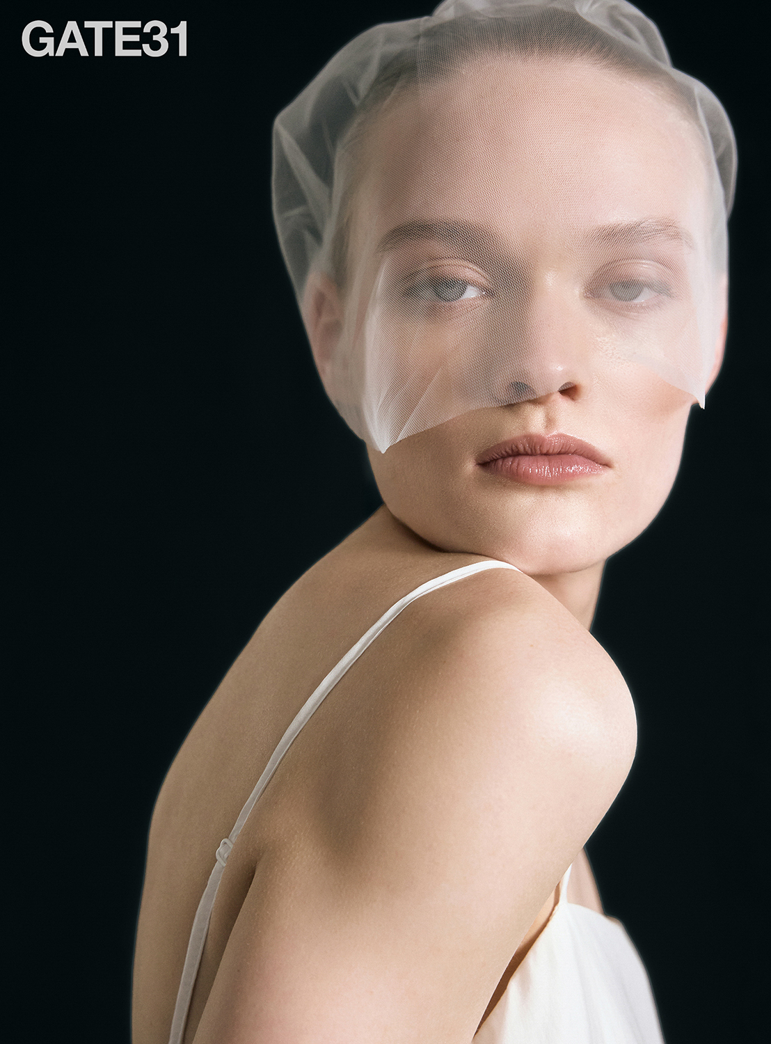 Gate31 beauty editorial — veiled portrait on a black background