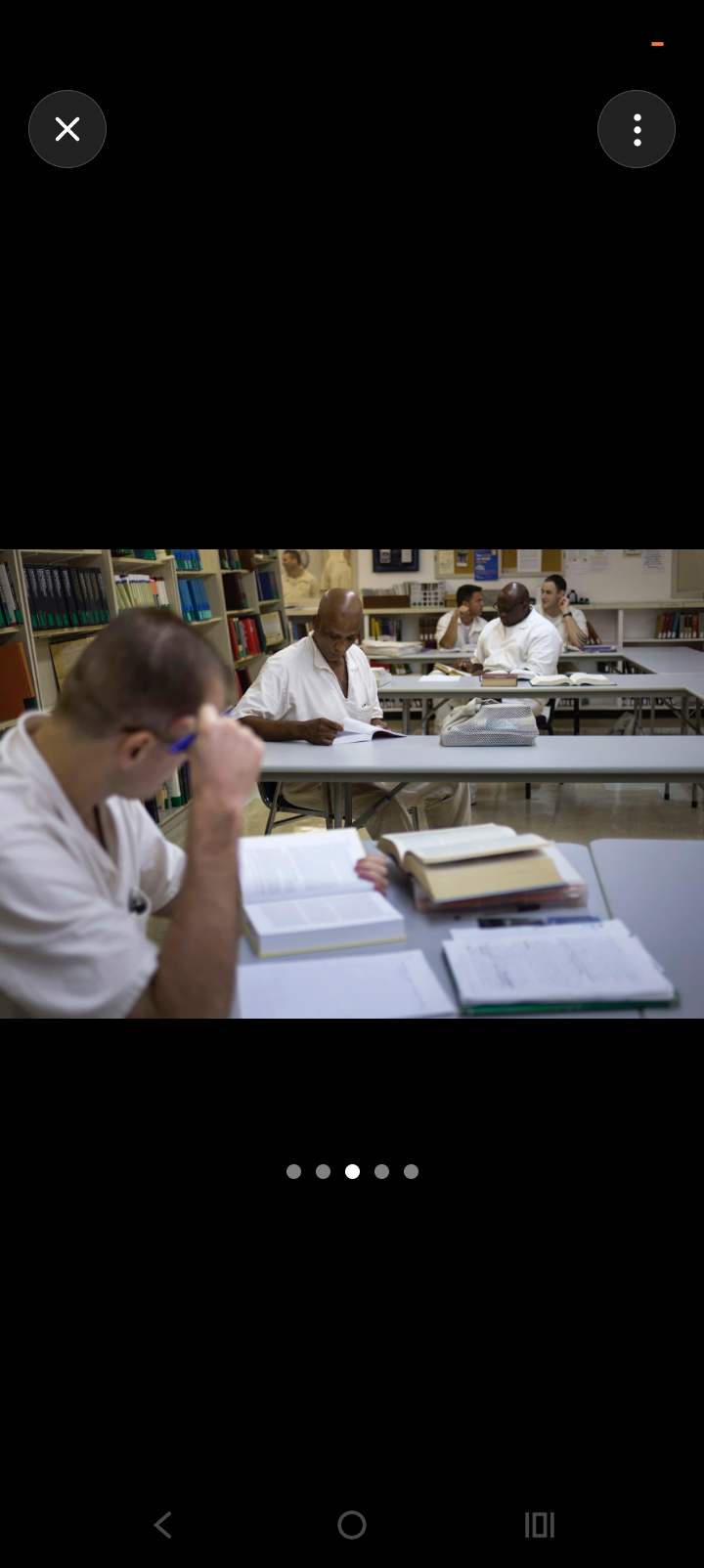 Incarcerated individuals studying in a prison library