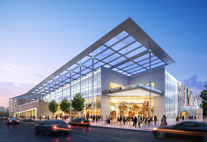 Modern glass shopping mall exterior at dusk