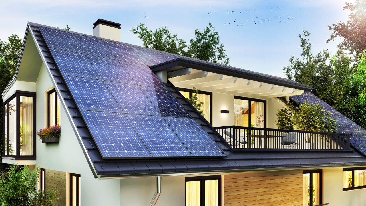 Modern house with solar panels covering the sloped roof, featuring white walls and wooden accents