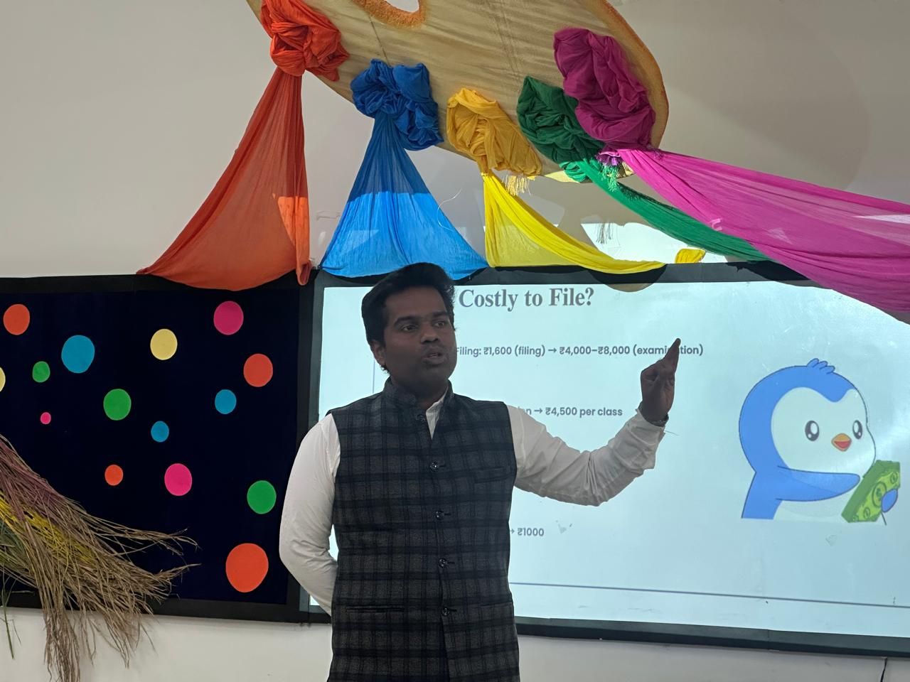 Dr. Umeshkumar KU explaining the cost of patent filing during a talk