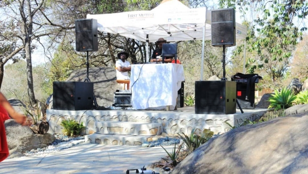Professional outdoor stage setup with sound system under tent