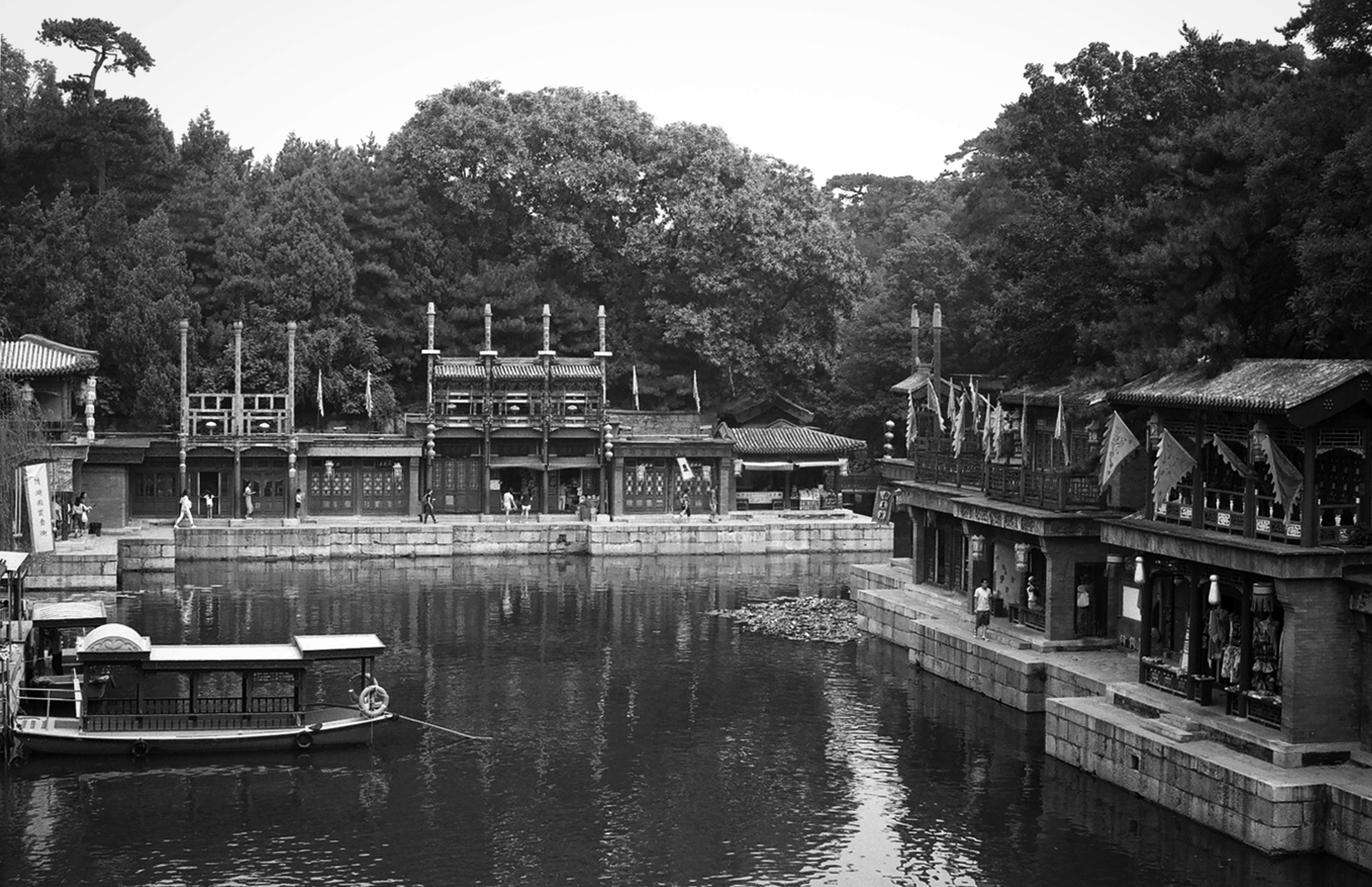 Traditional waterside pavilions with boats at Summer Palace lake