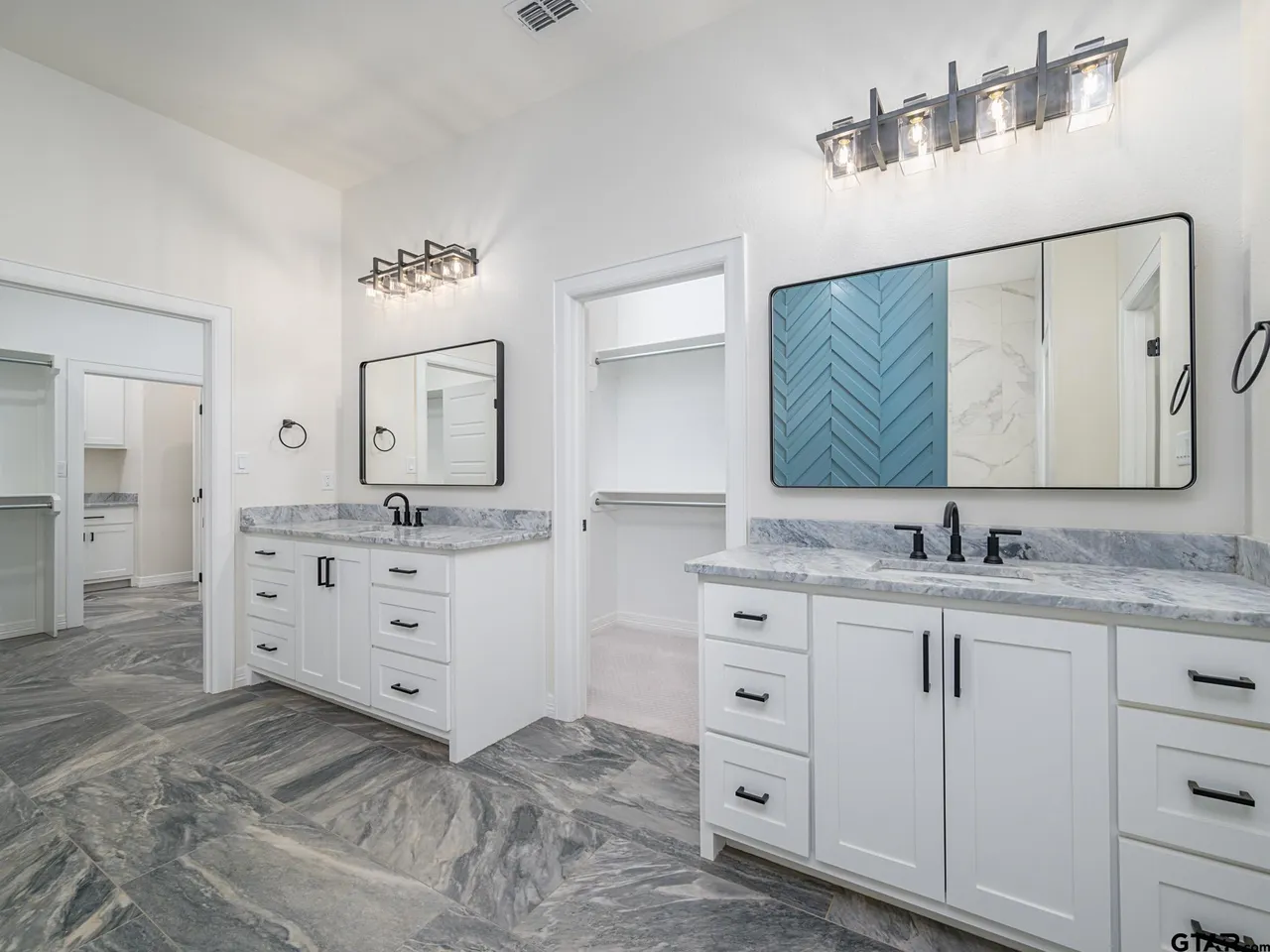 Master bath with dual vanities and marble countertops