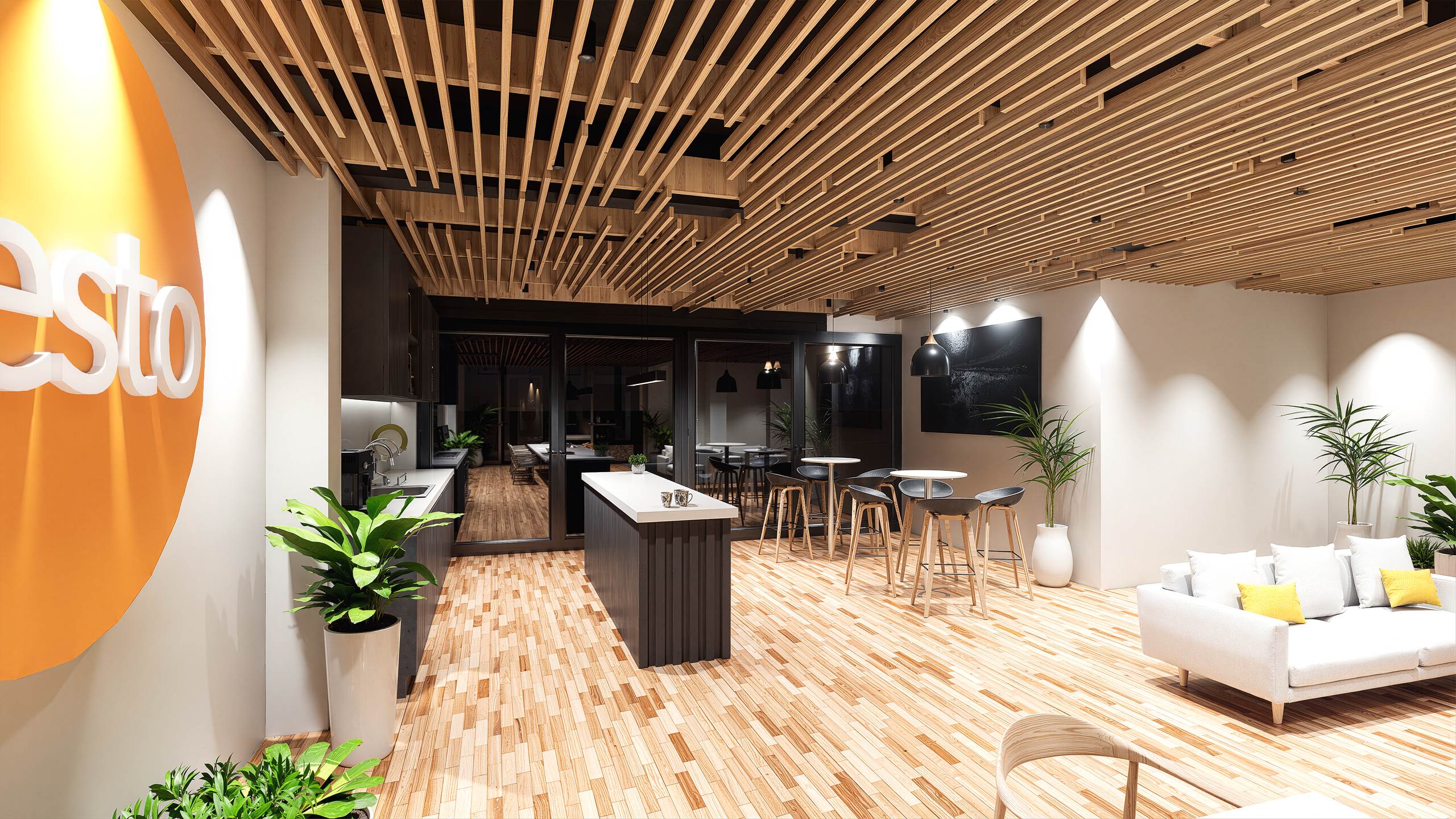 Area de break con isla central, banquetas altas, logo en pared naranja y cielorraso de madera