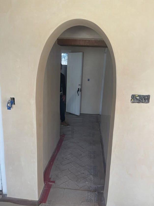 Single arched doorway with smooth cream plaster finish