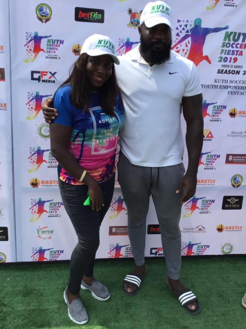 Founder with female volunteer at tournament backdrop