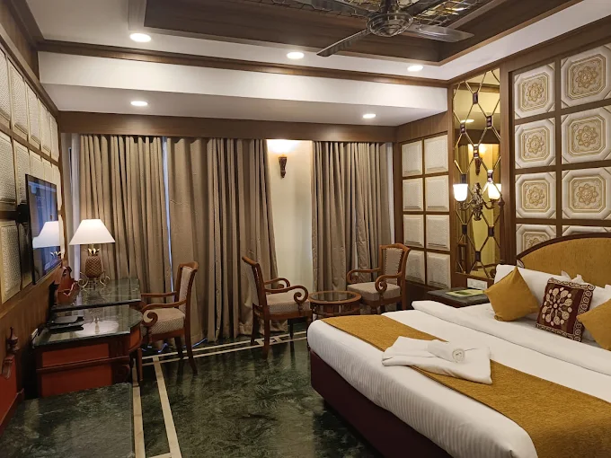Classic Room with twin beds, warm wood furnishings, and gold accents
