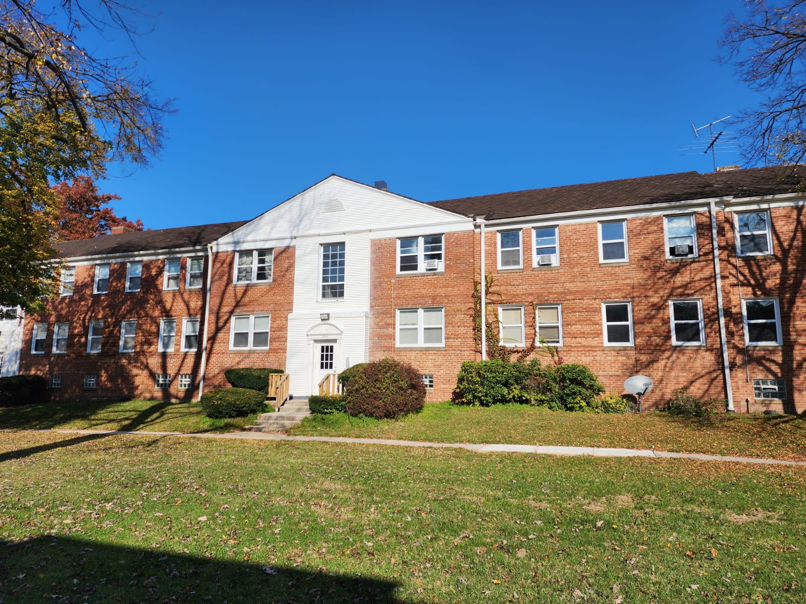 Brick apartment building exterior on Forest Hills Boulevard in East Cleveland, Ohio — two-story residential building with white-trimmed entrance