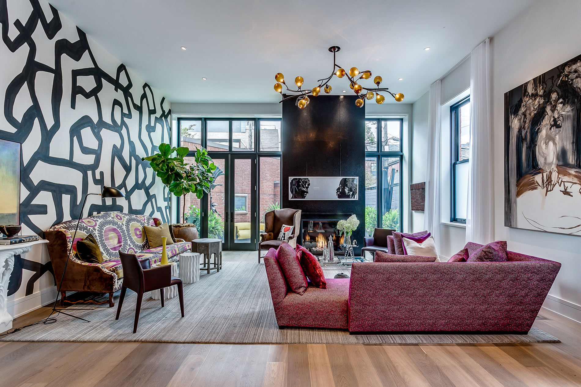 Eclectic living room with burgundy sofa and abstract wall art
