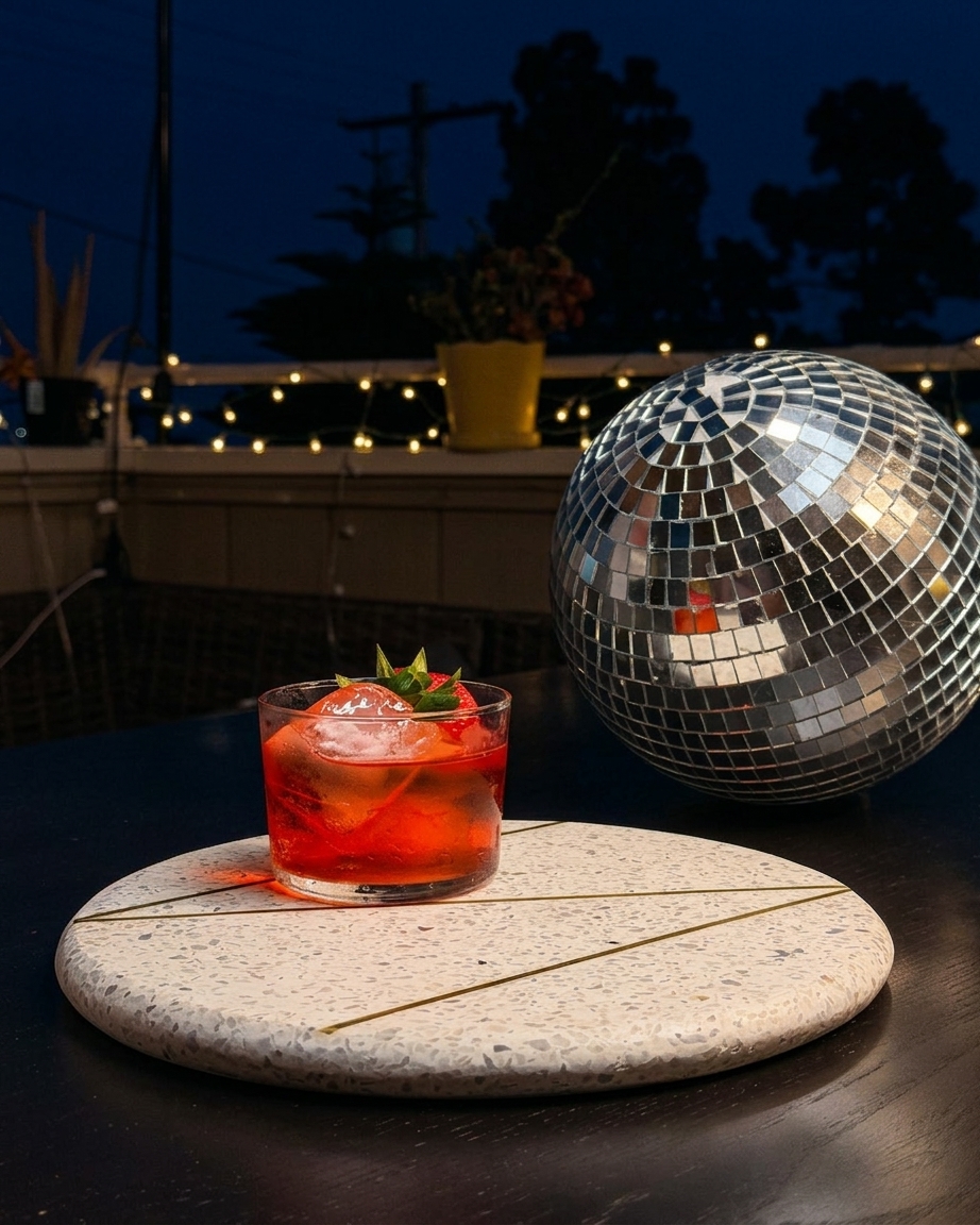 Red cocktail with strawberry and disco ball