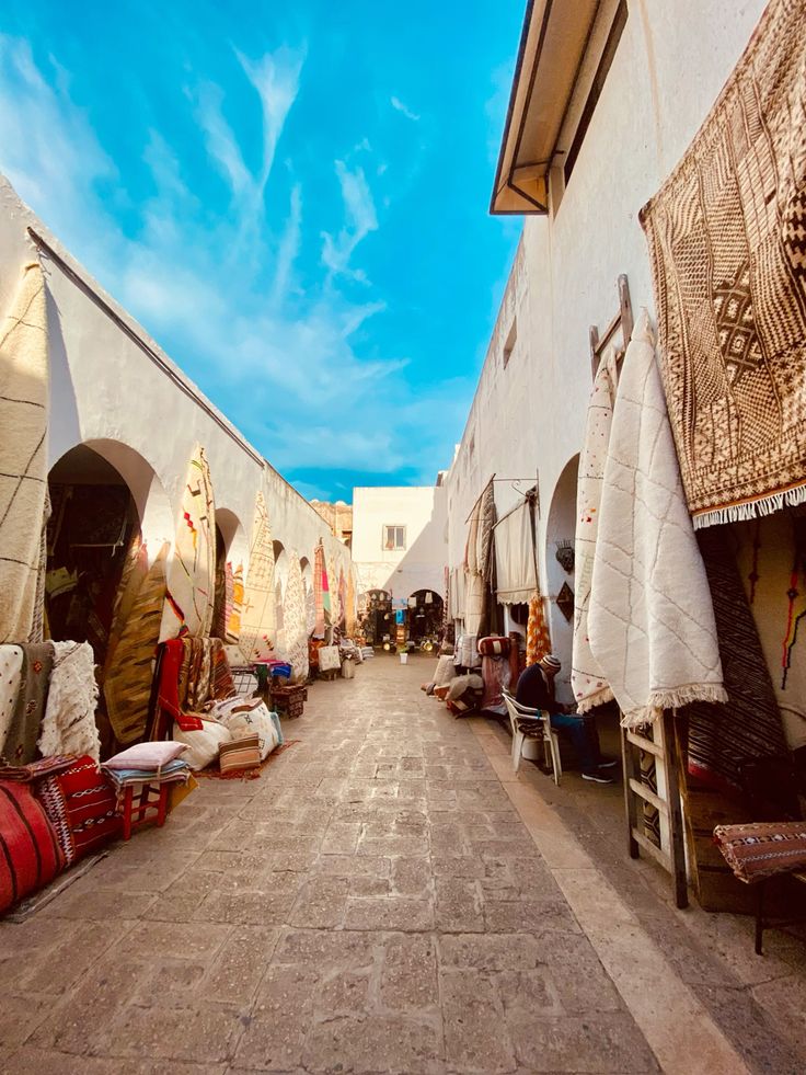 Traditional medina souk alley with colorful rugs and carpets in Morocco