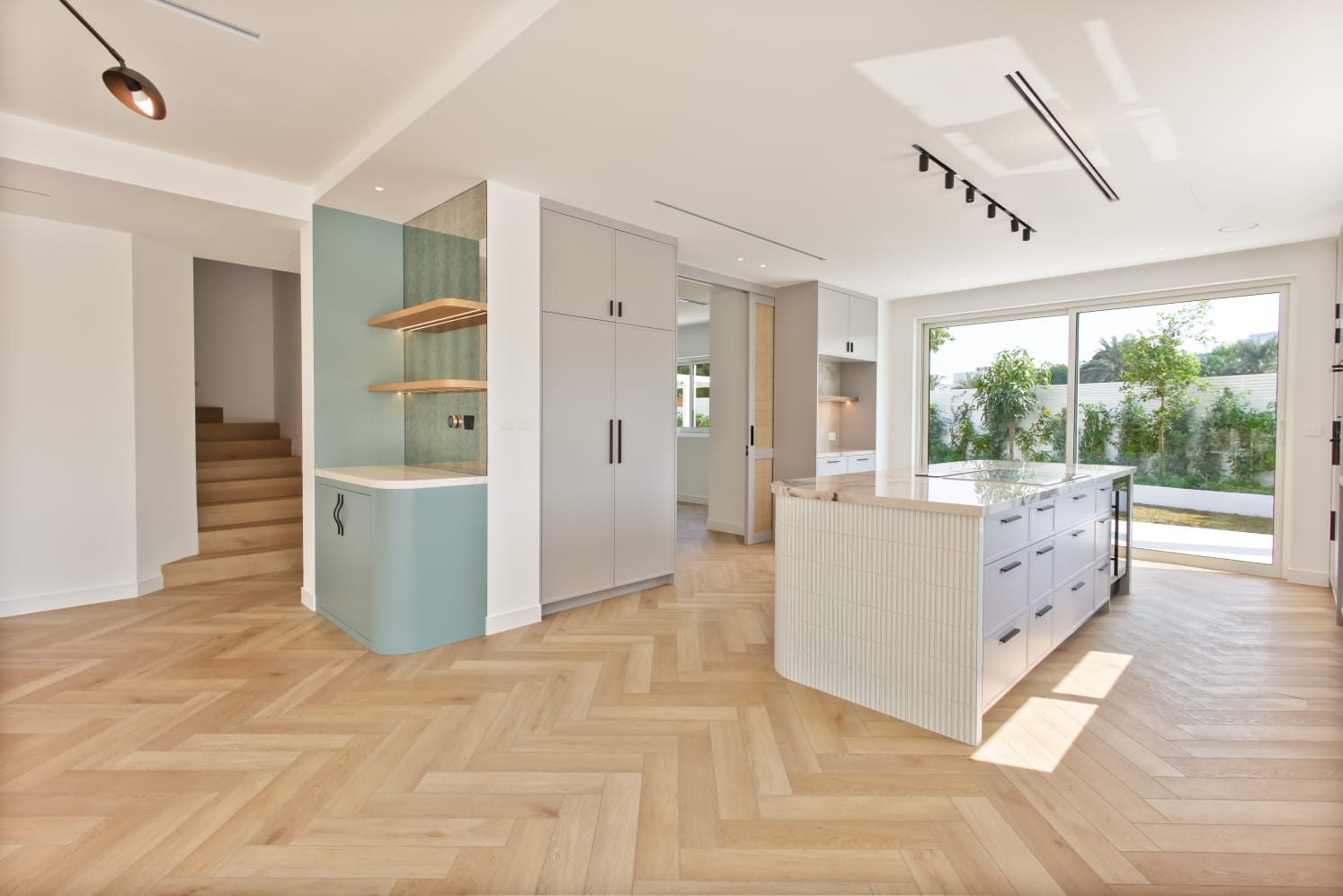 Modern kitchen with herringbone floor and garden view