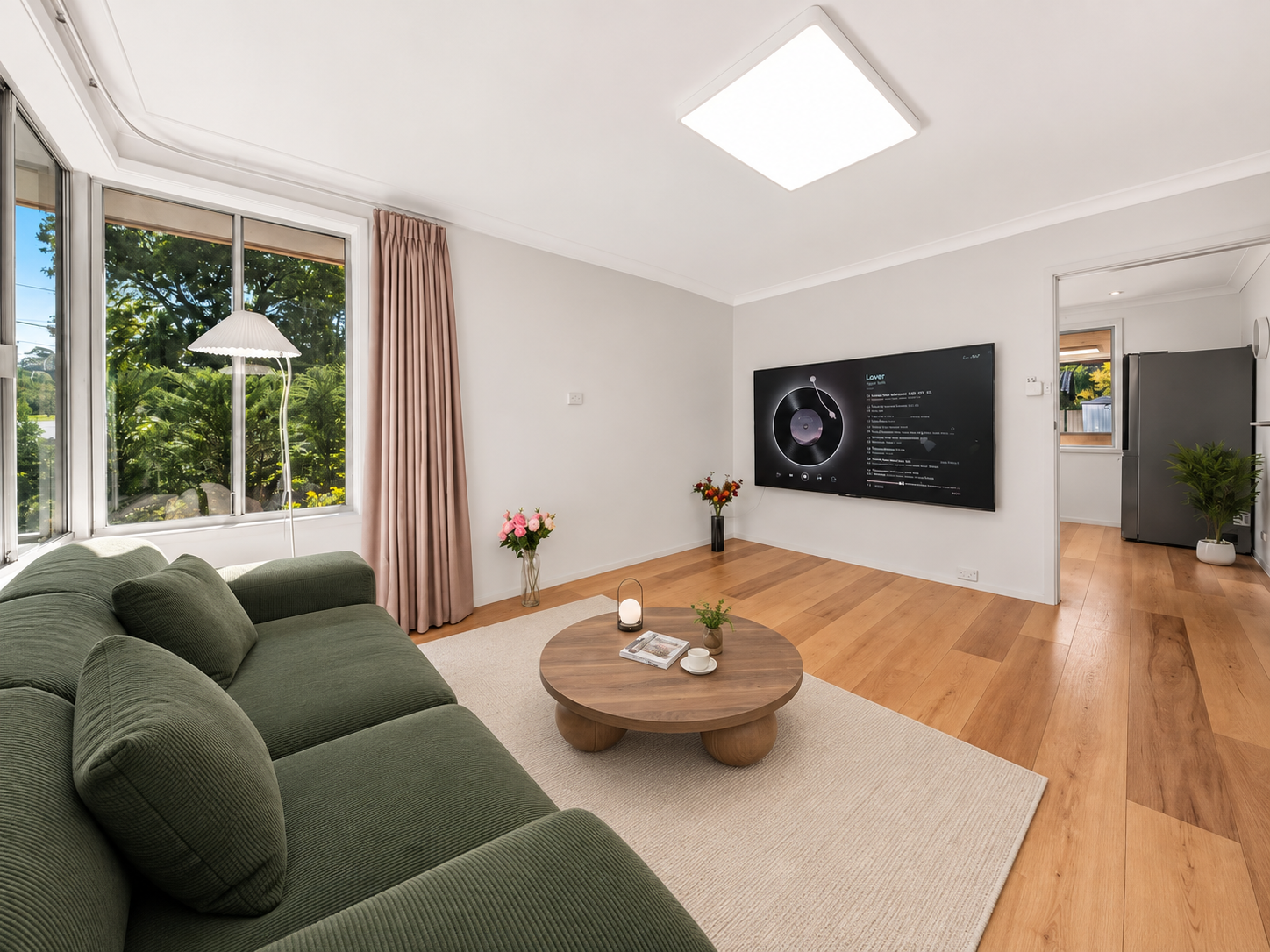 Bright living room with comfortable seating and television