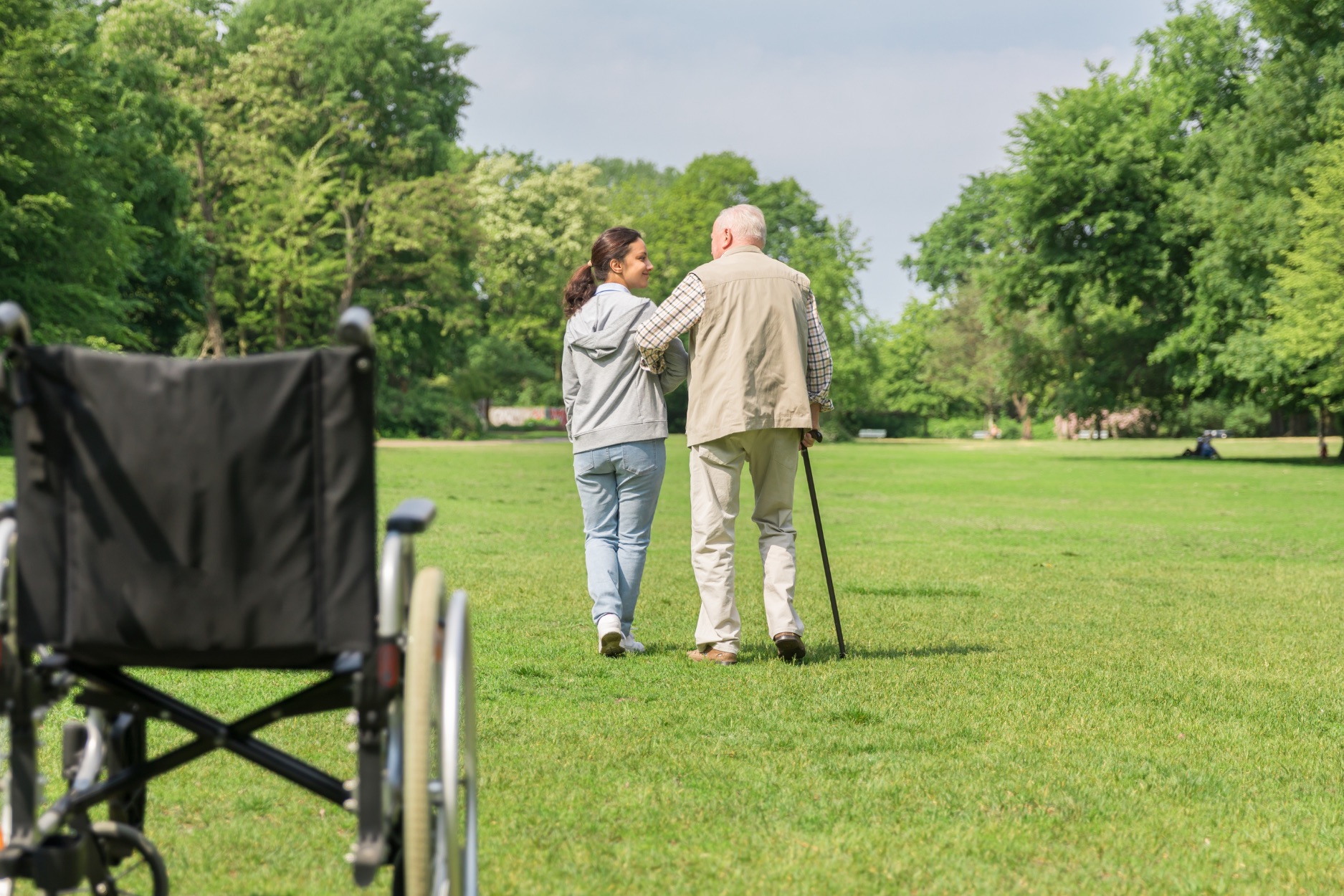 Caregiver and patient walking together outdoors