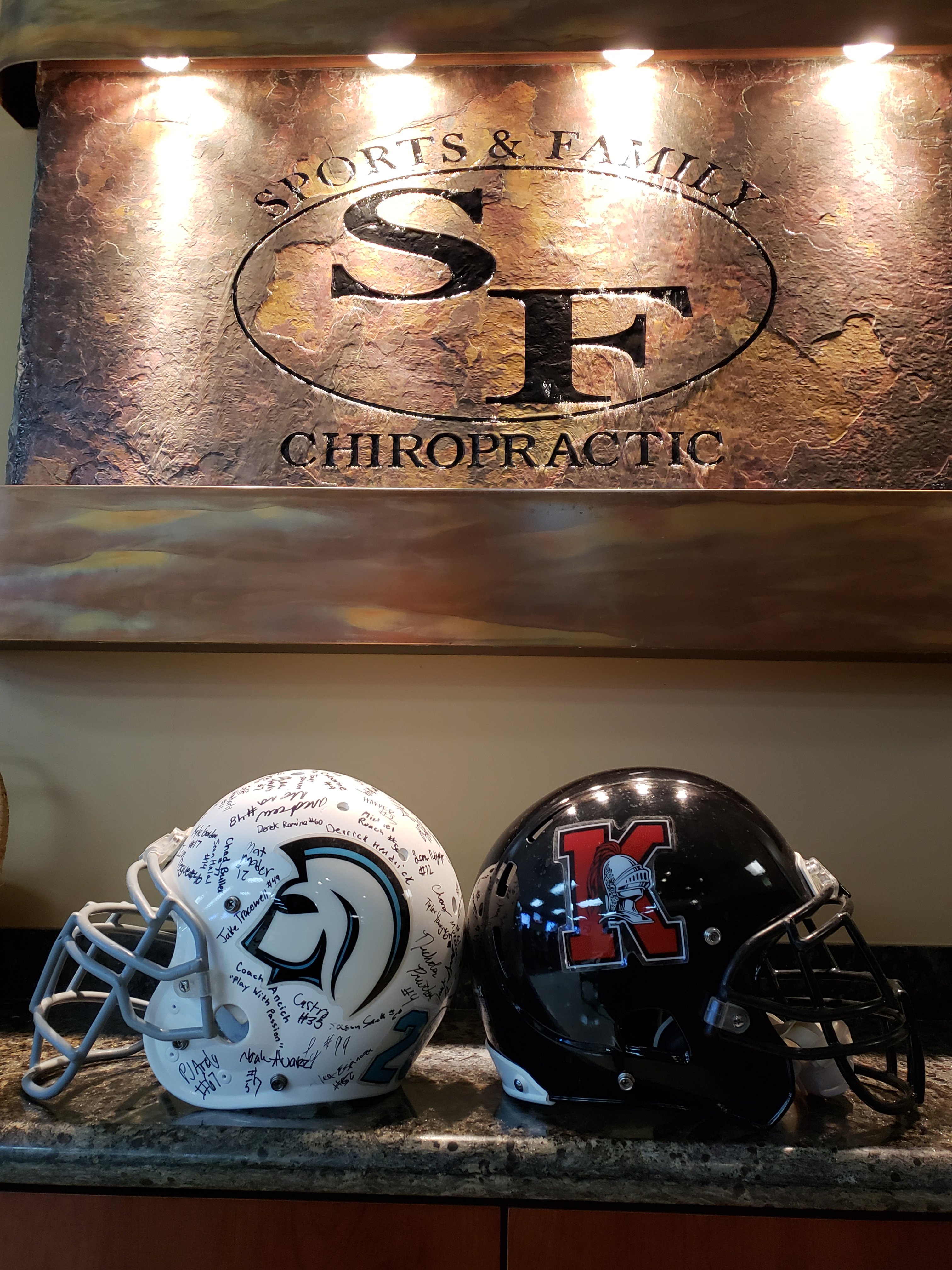 Signed team helmets at Sports & Family Chiropractic office
