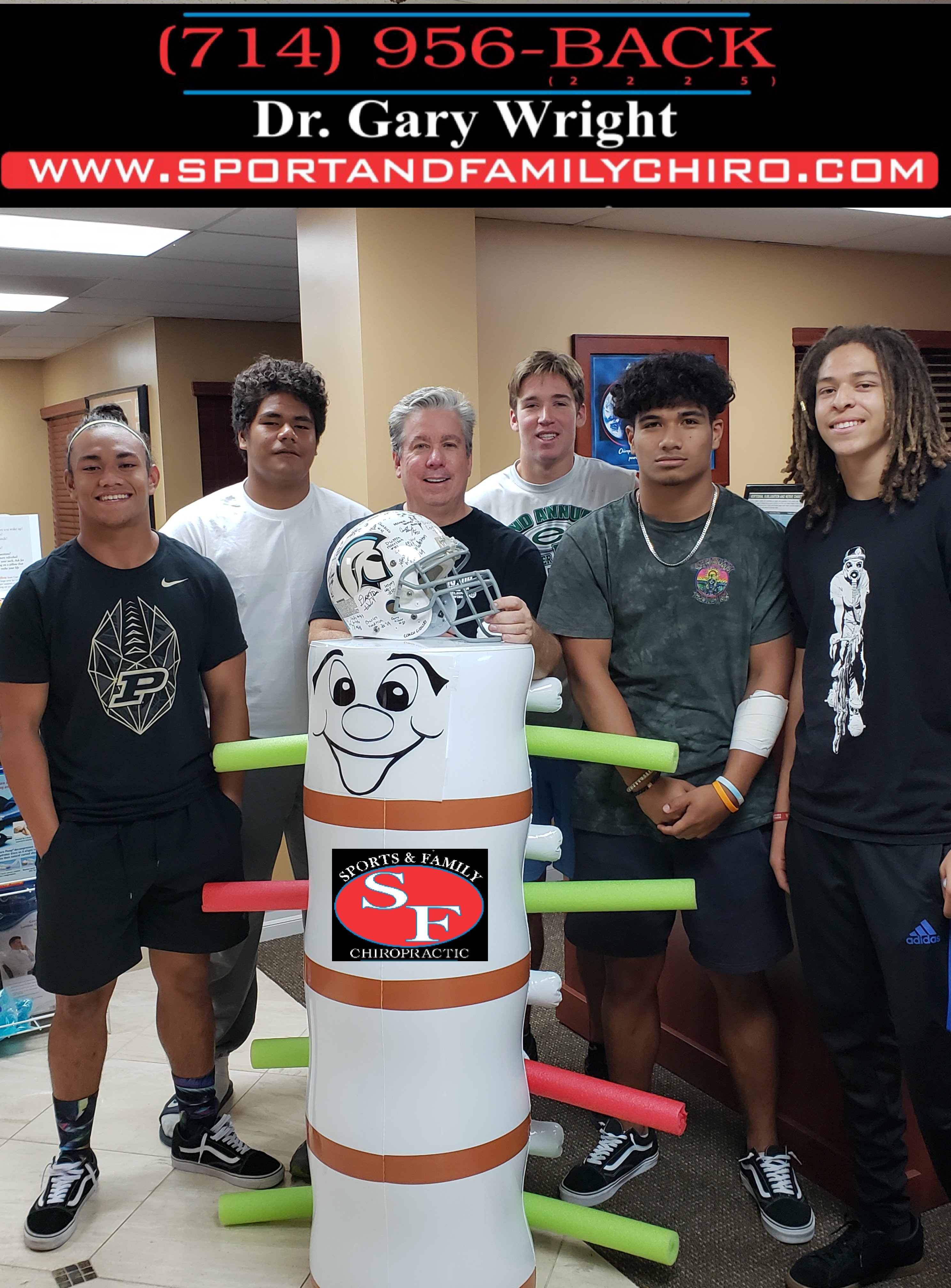 Dr. Gary with athletes posing by spine mascot