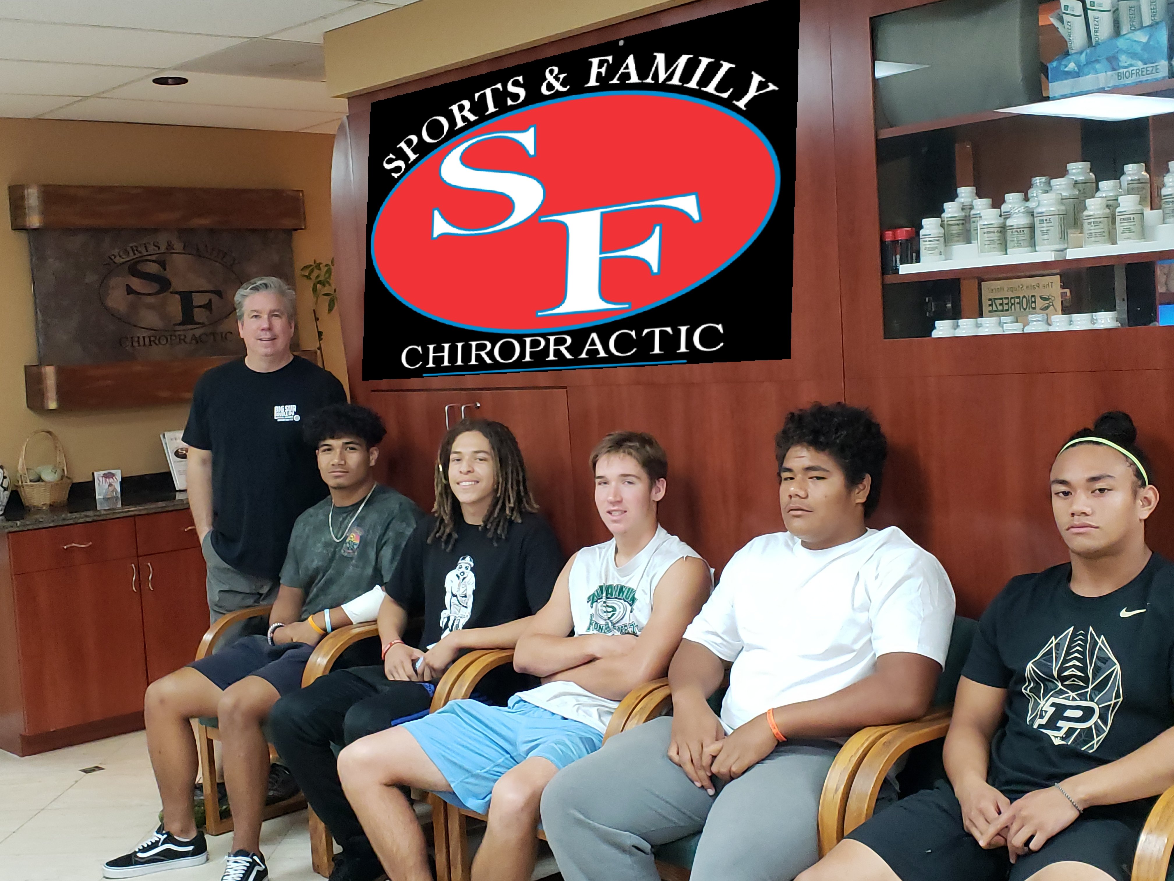 Dr. Gary with group of student athletes at office
