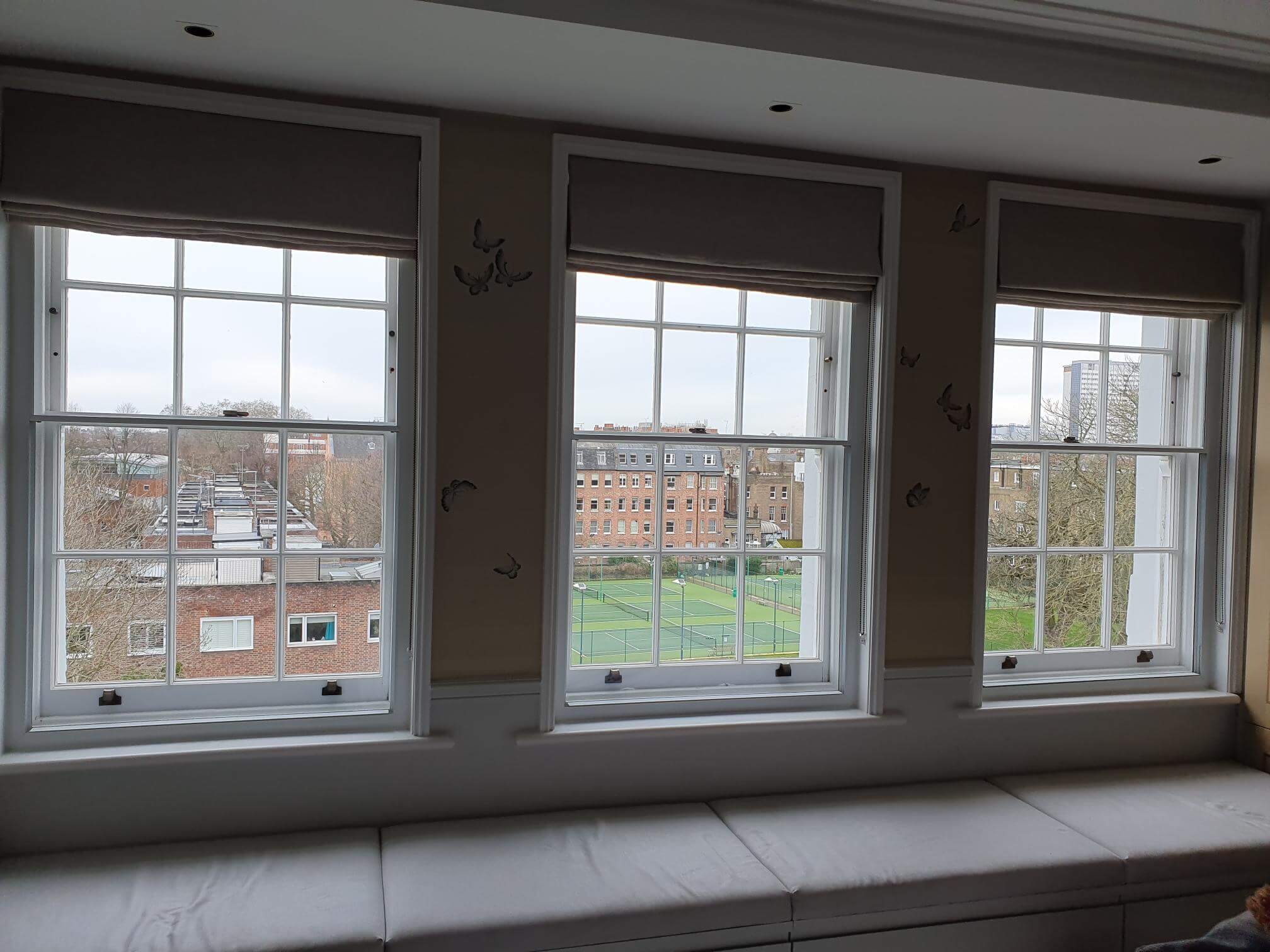 Three Georgian sash windows with secondary glazing and roman blinds in London Maida Vale property overlooking tennis courts