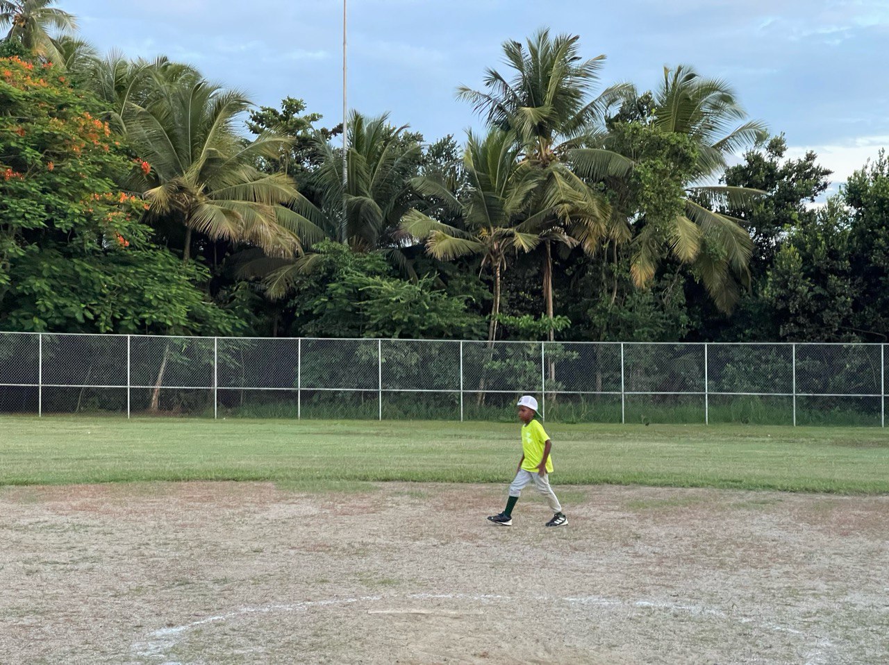 Person walking across field showing current conditions