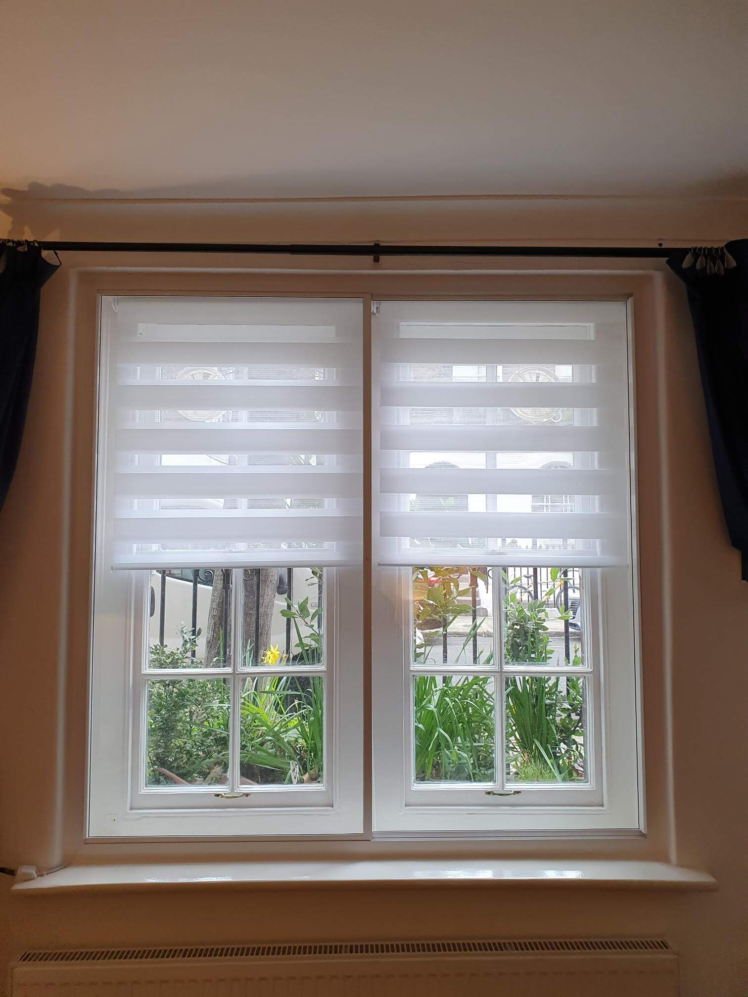 Twin casement windows with secondary glazing and day-night blinds in London Islington property overlooking garden