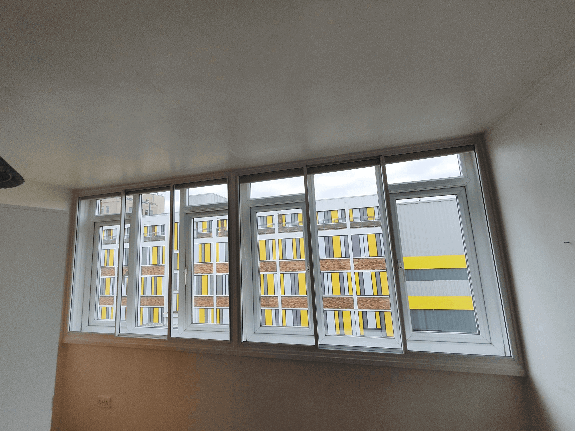Wide six-panel casement secondary glazing in London Hackney modern apartment building
