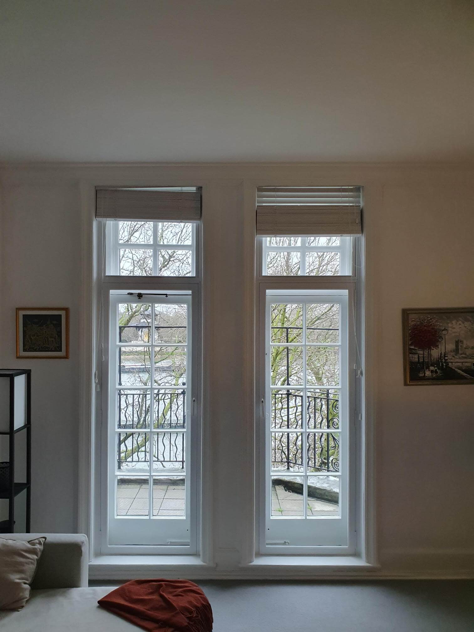 Two Georgian windows with secondary glazing panels in London Chelsea period living room with winter river views