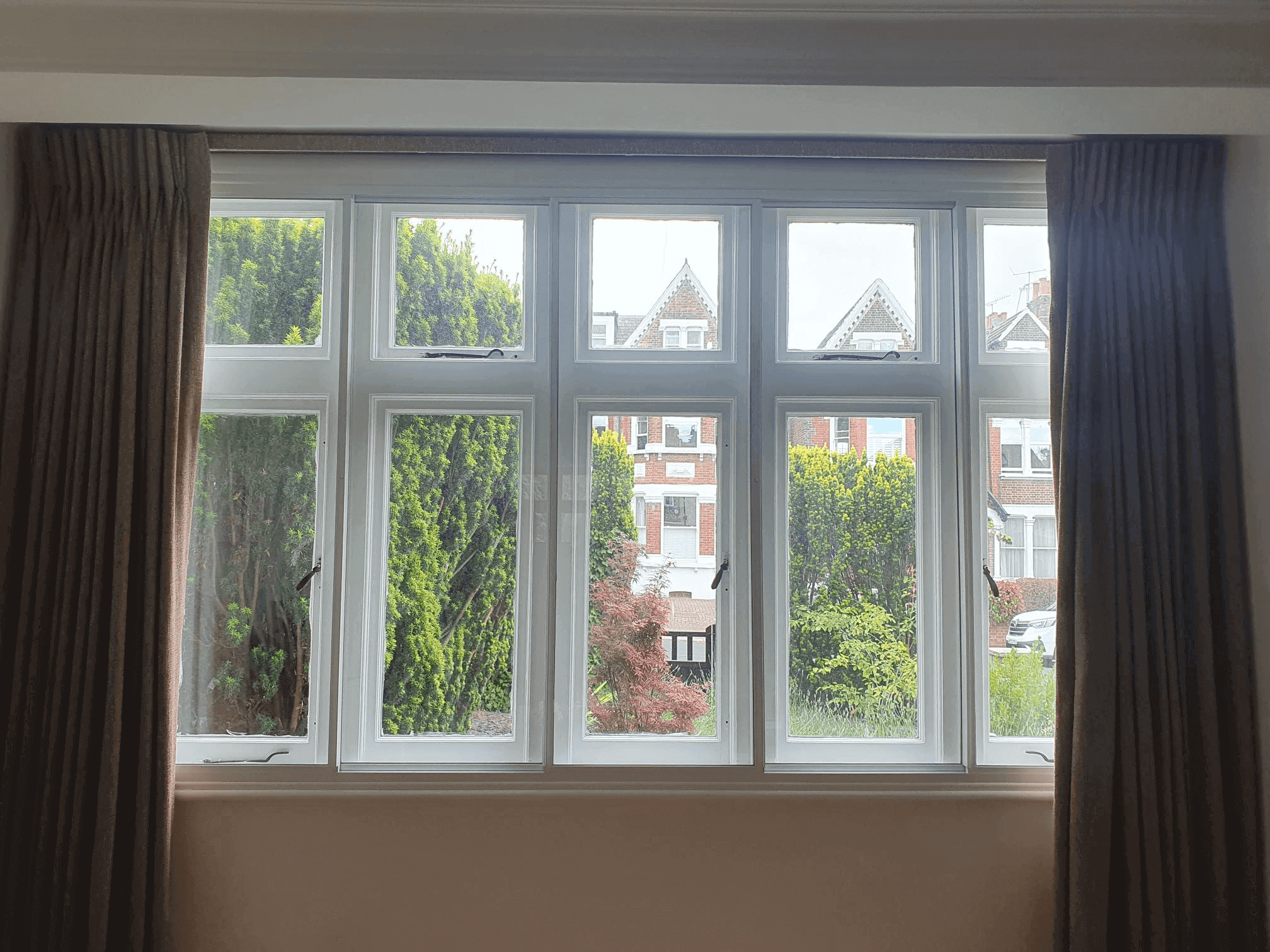 Four-panel Edwardian casement windows with secondary glazing in London Muswell Hill home overlooking garden
