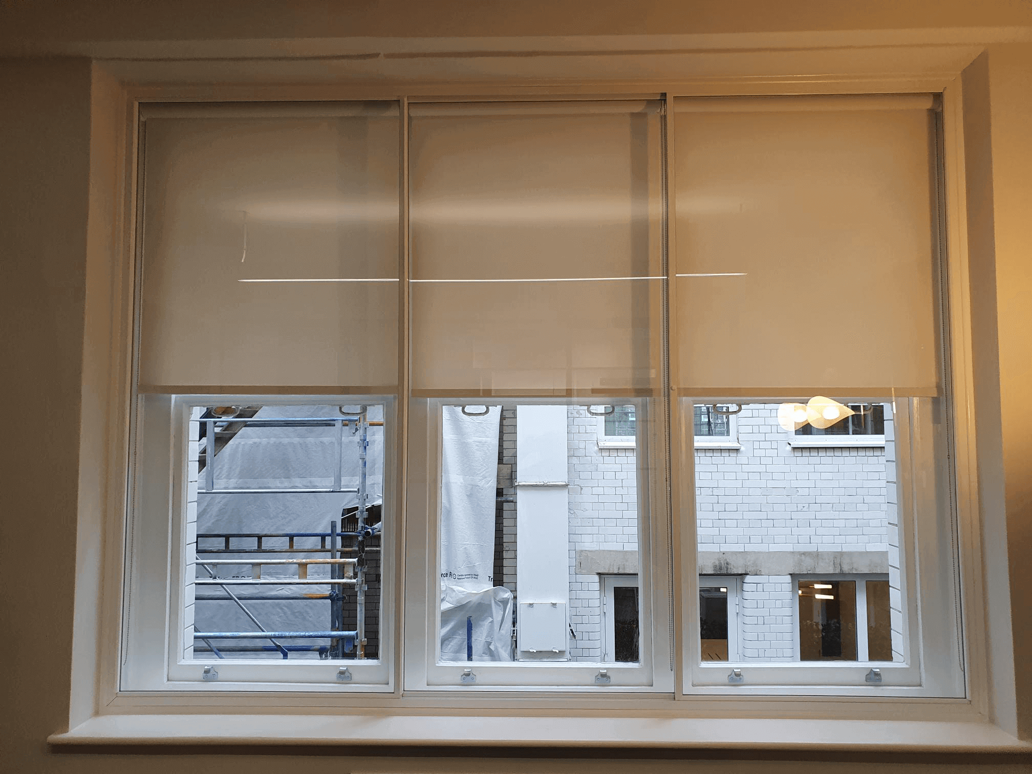Triple sash windows with secondary glazing and roller blinds in London Marylebone flat