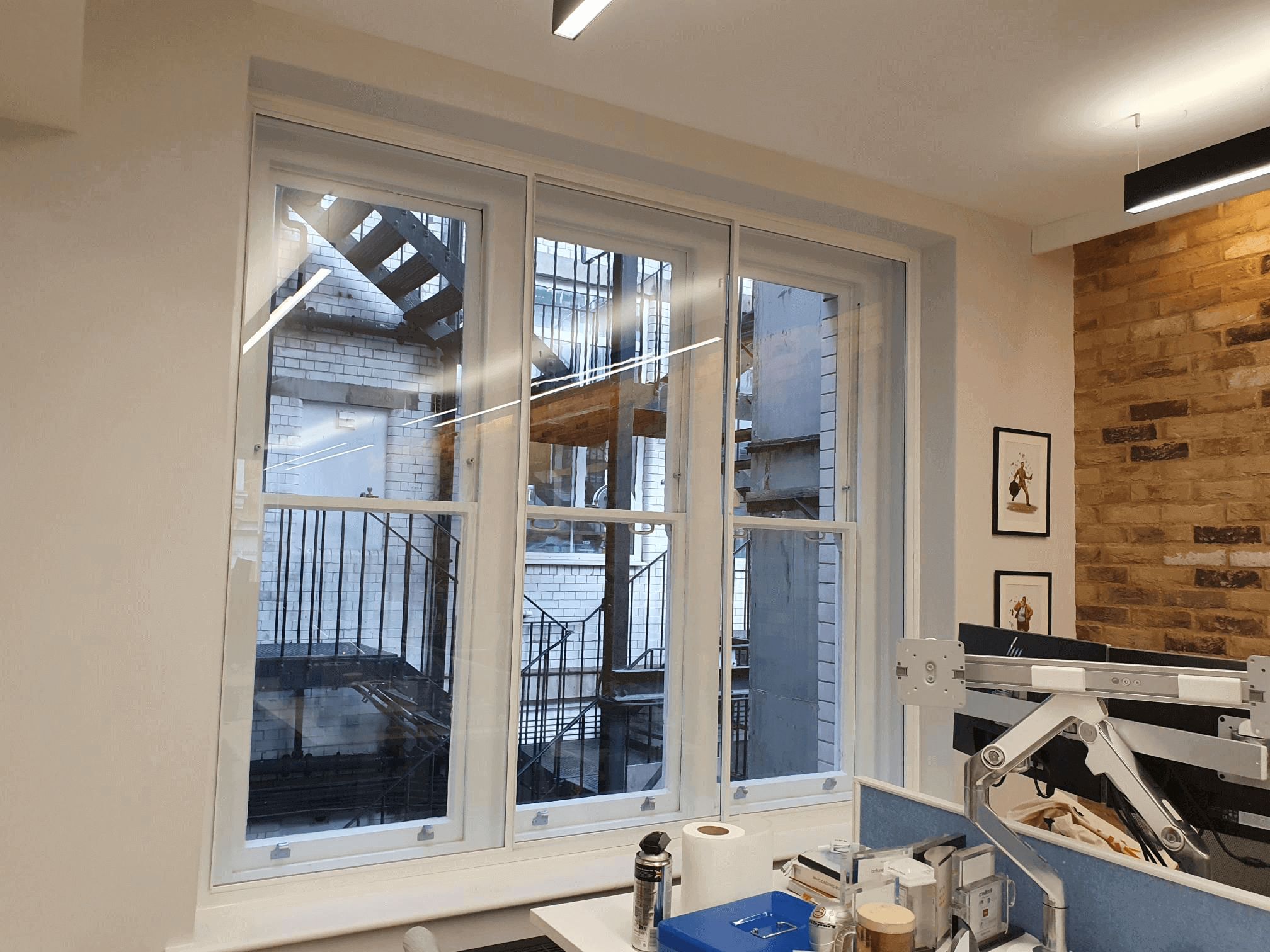 Commercial secondary glazing in London Clerkenwell dental practice with exposed brick wall