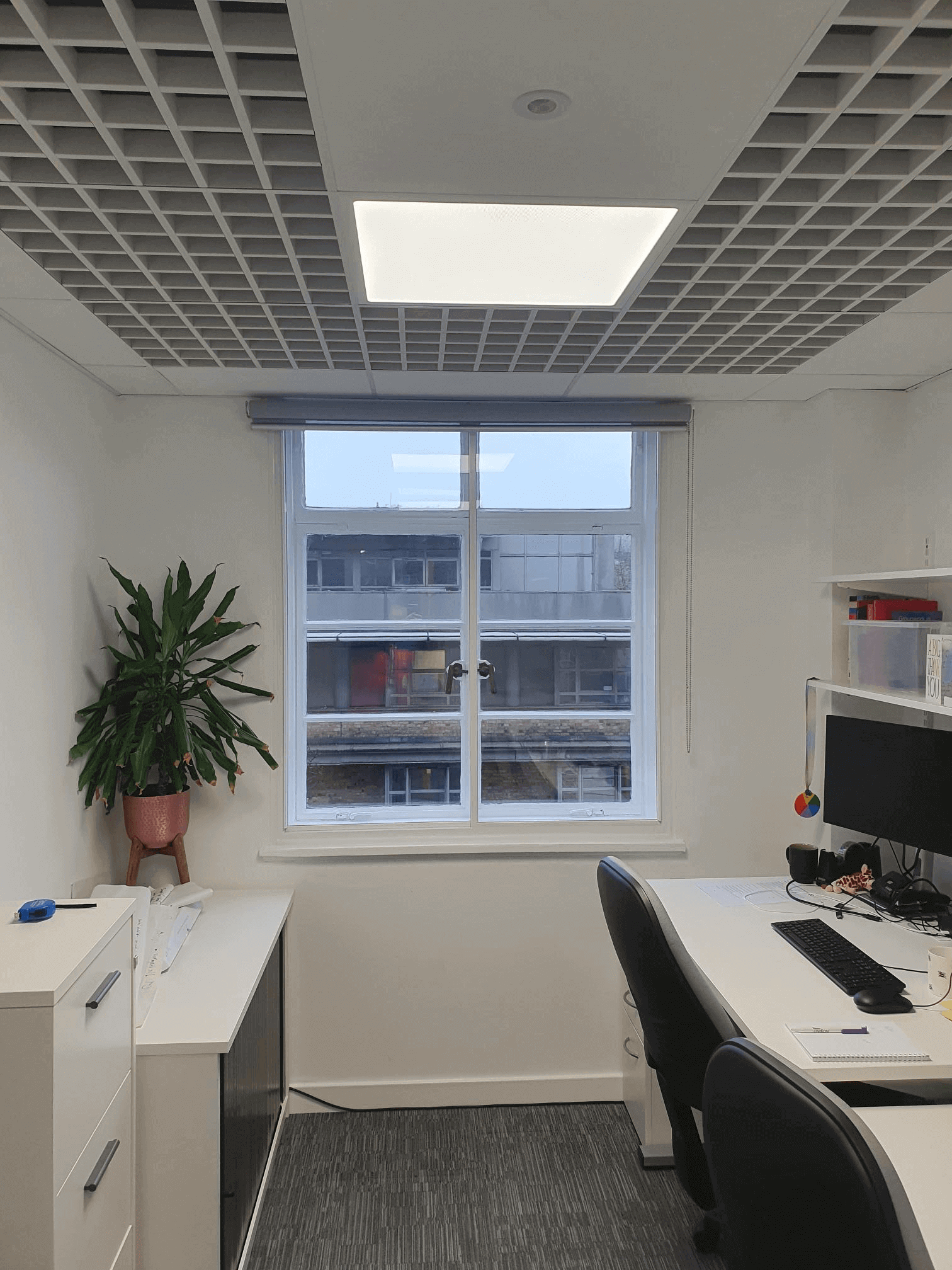 Casement secondary glazing in London City commercial office with grid ceiling and workstations