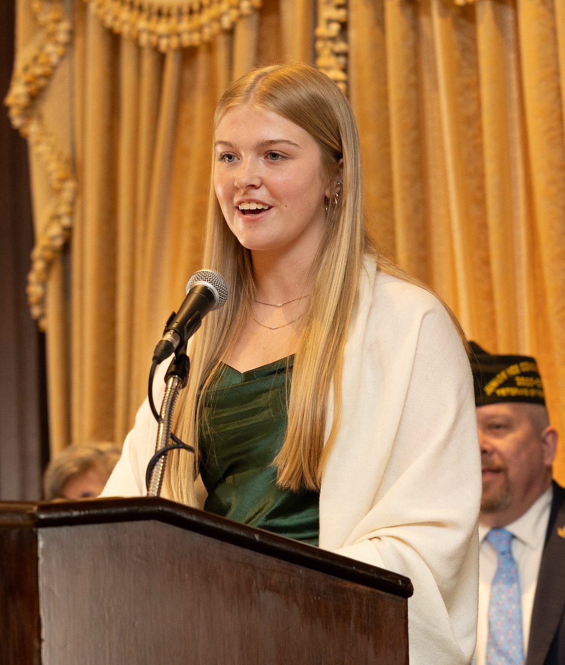 A VFW scholarship recipient speaking at a podium during an awards ceremony