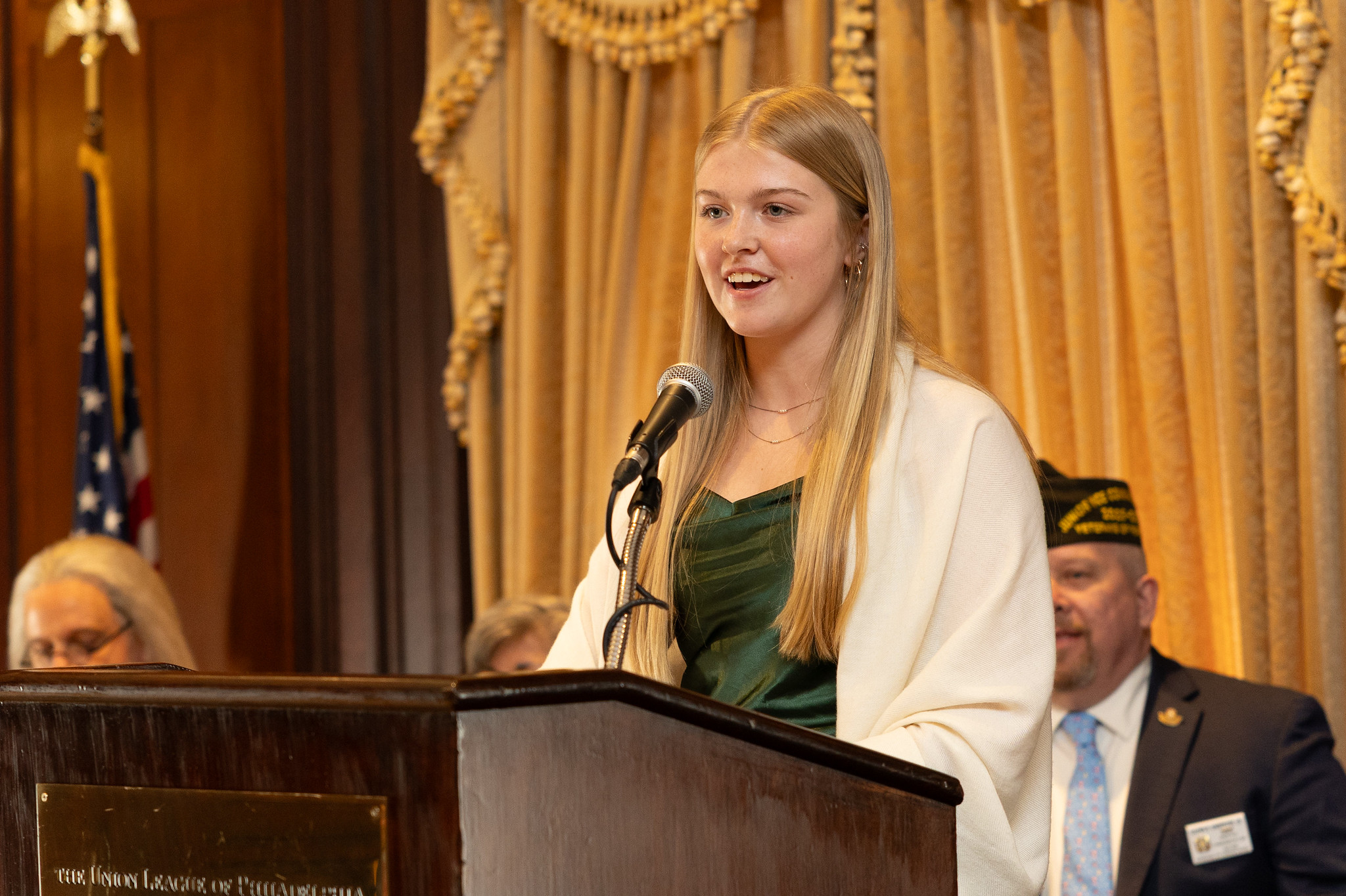 A VFW scholarship recipient speaking at a podium during an awards ceremony