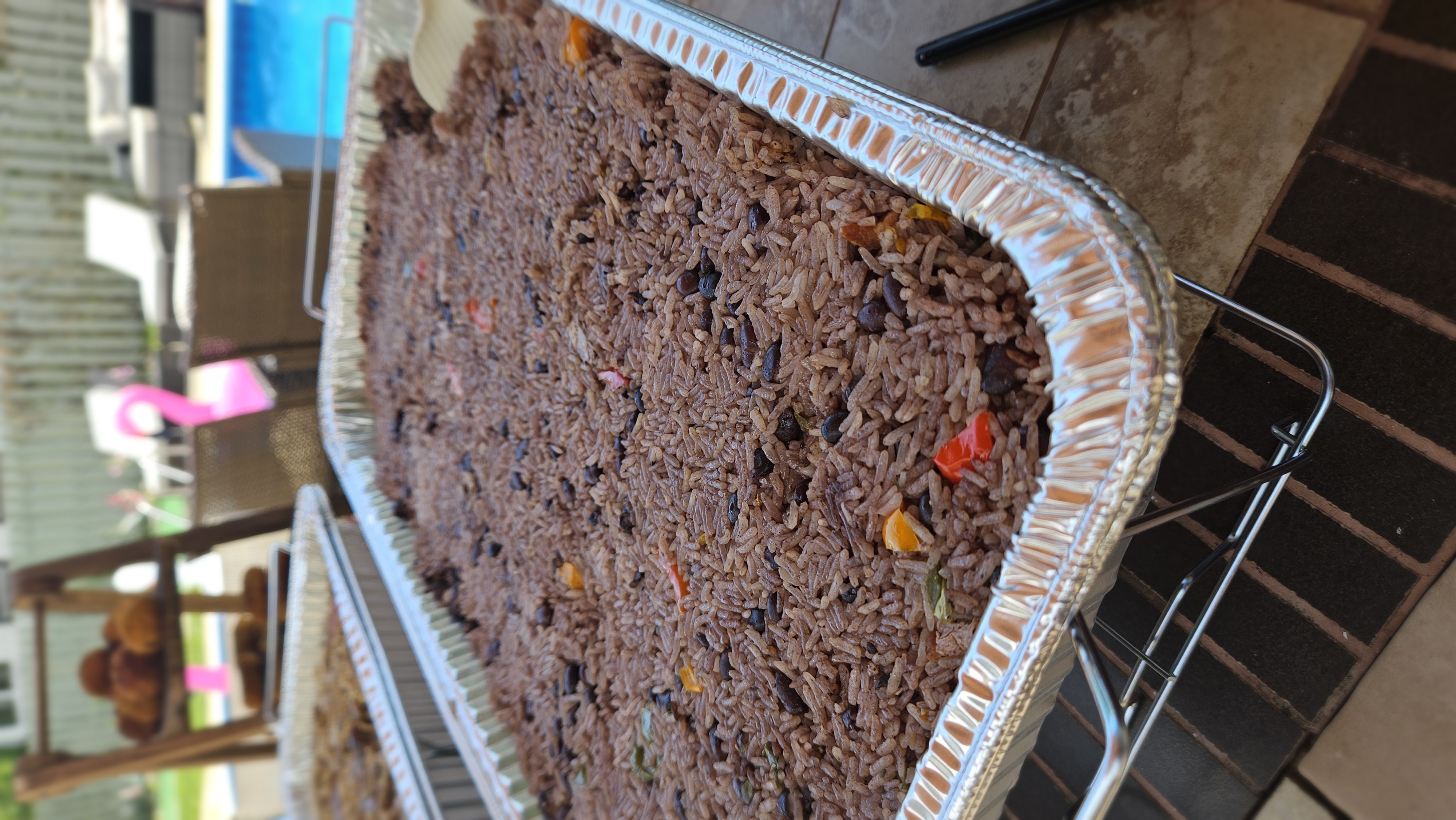 Black beans and rice with peppers in a catering tray