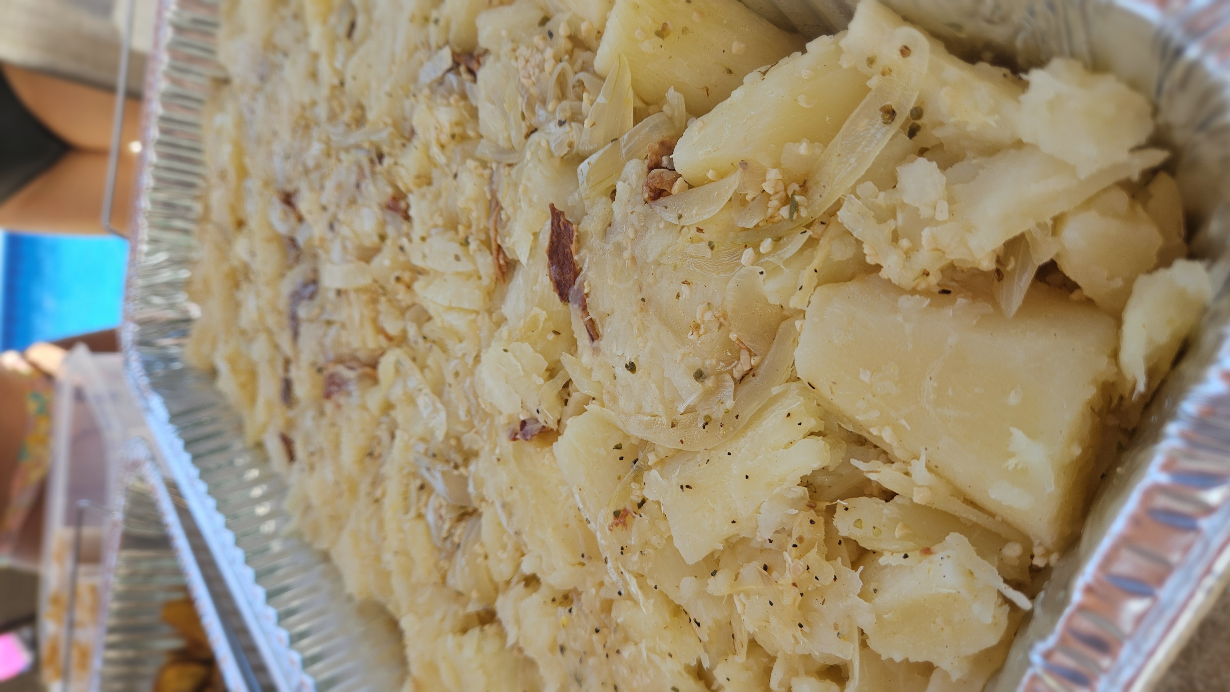 Yuca with garlic and onions in a catering tray