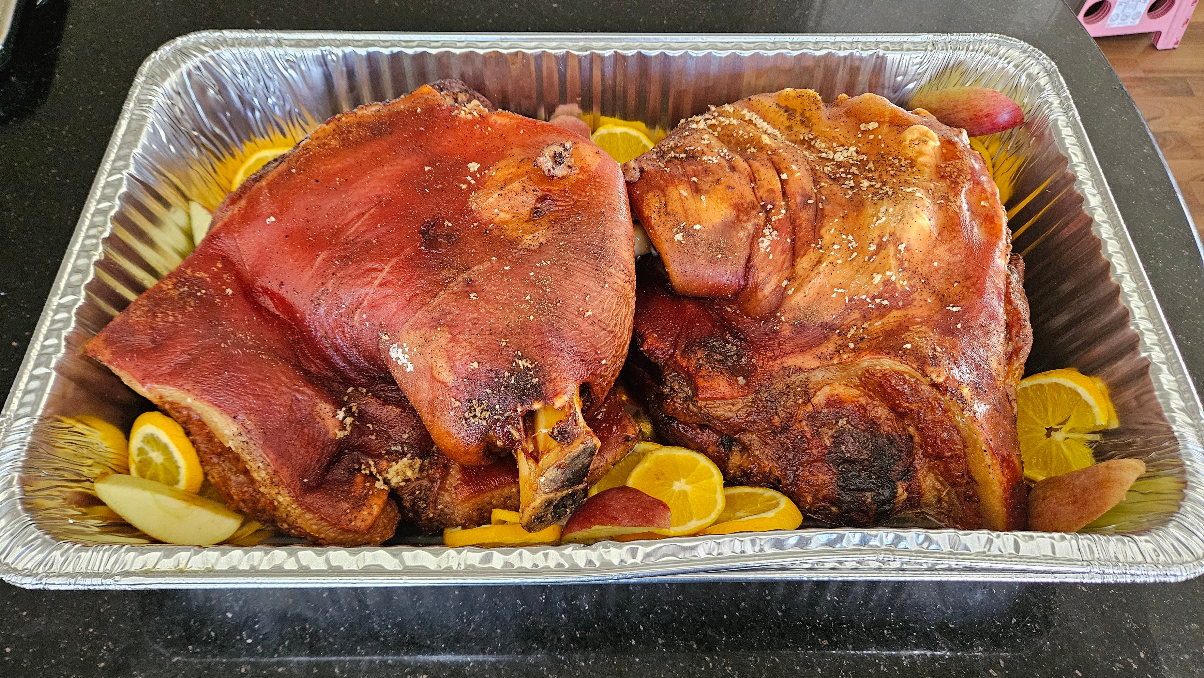 Roasted pork shoulder with citrus slices