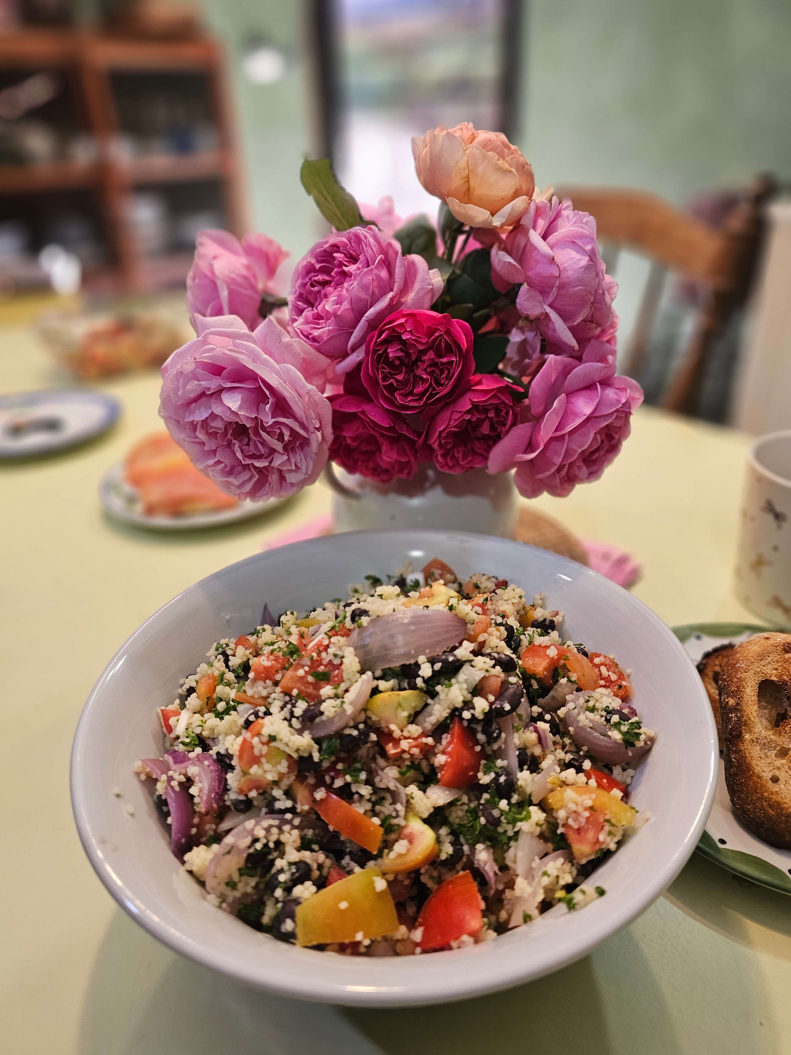 Quinoa salad with vegetables and pink roses centerpiece