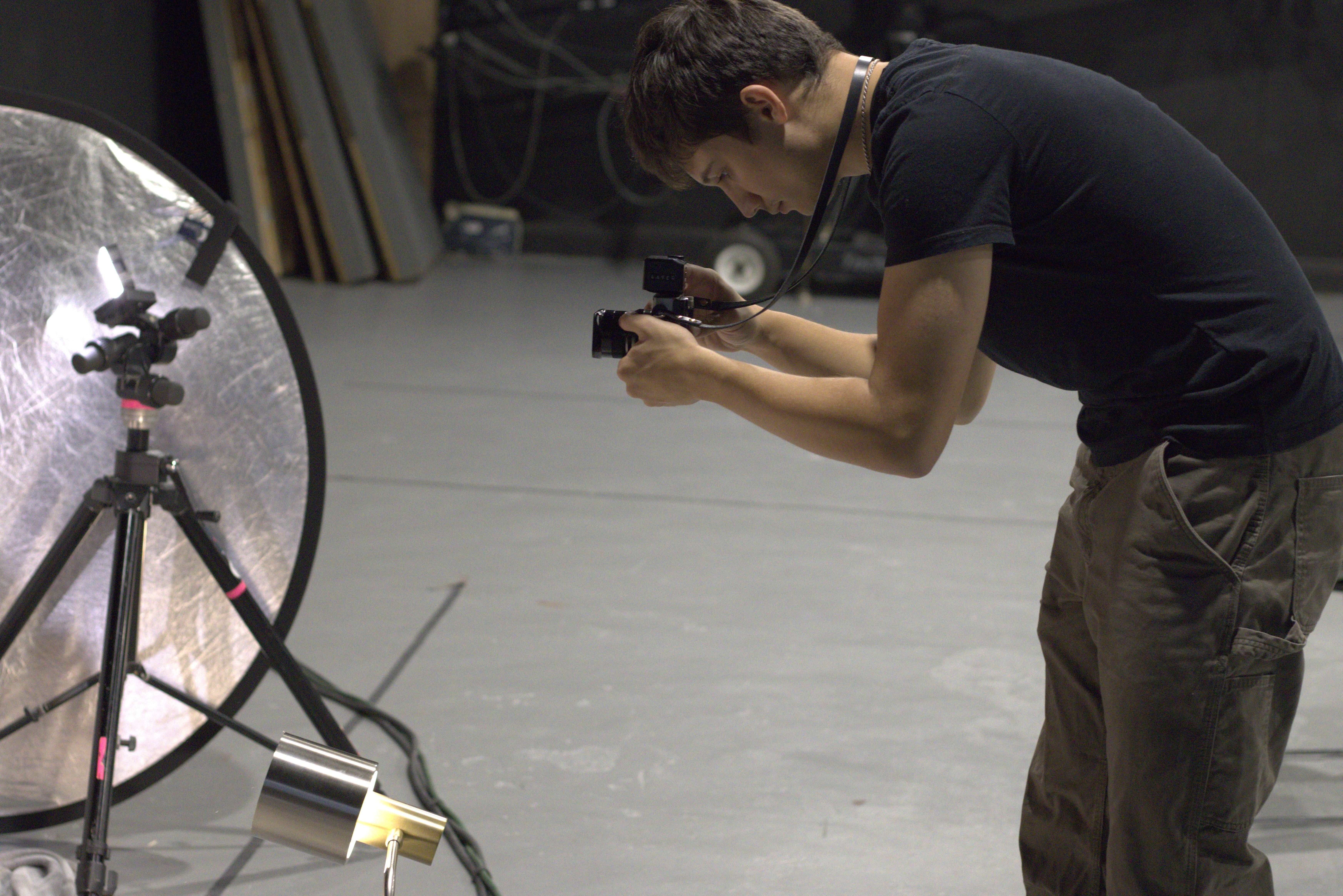 Photographer in action with studio equipment