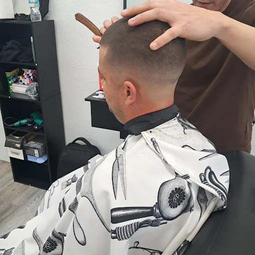 Barber working on client haircut