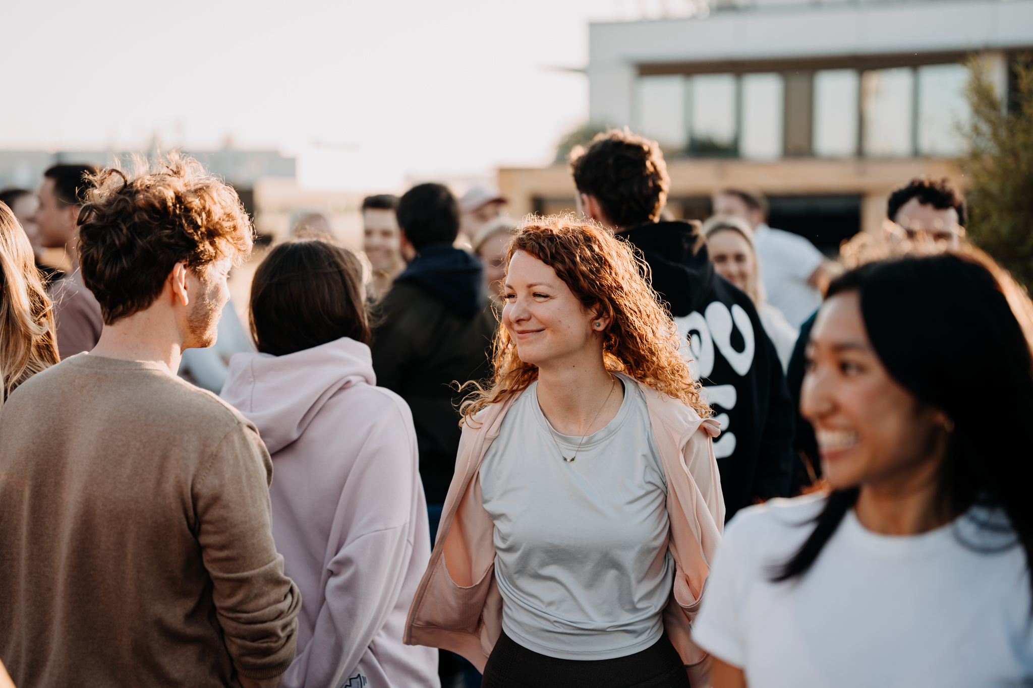 Facilitator guiding a circle of participants seated on mats