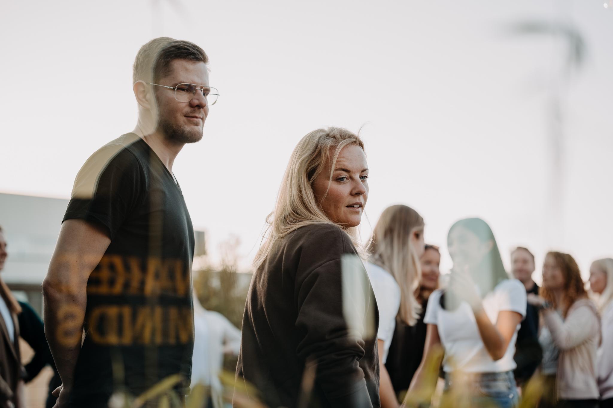 Two guests on a rooftop terrace in golden evening light
