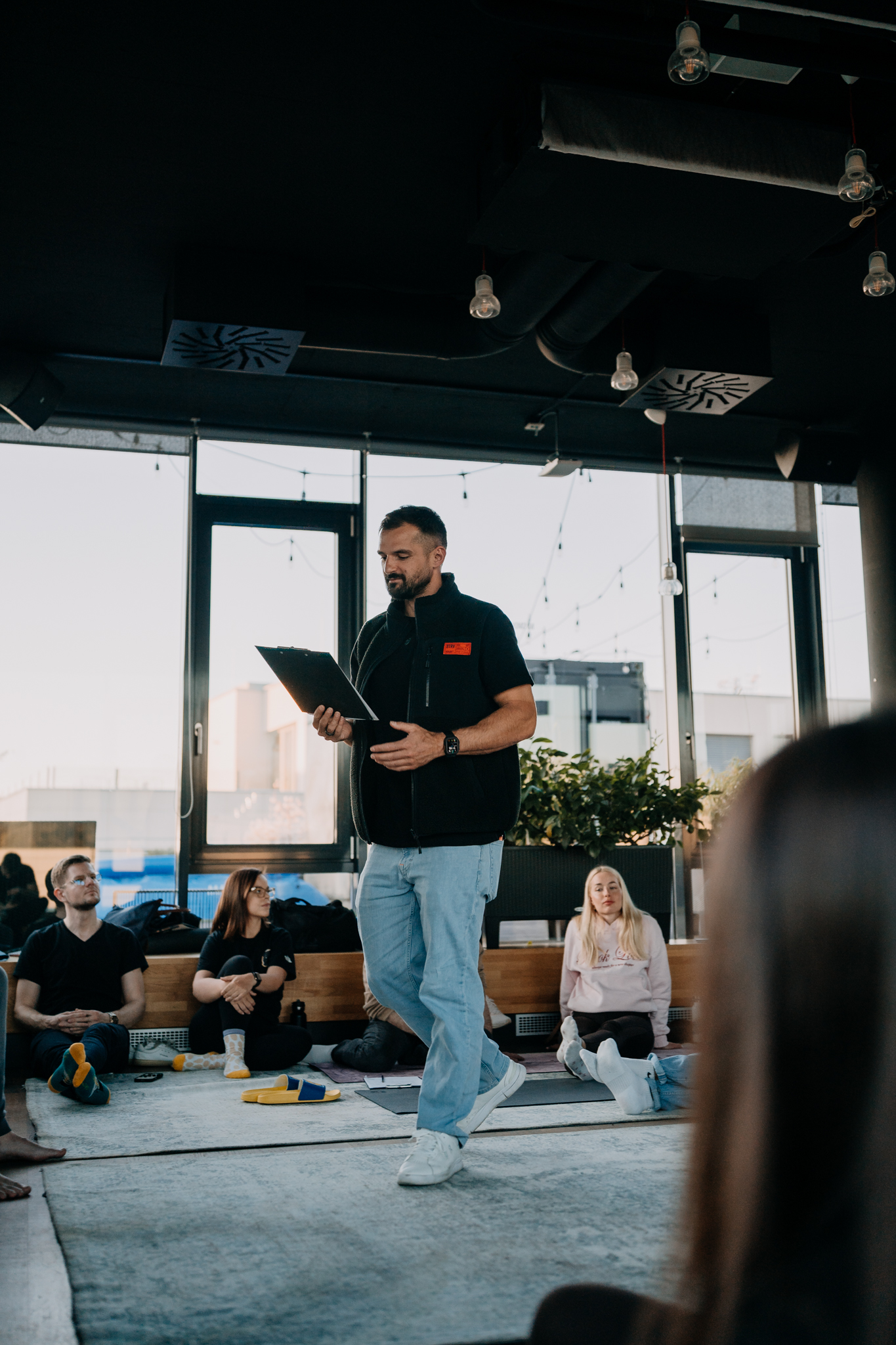 Facilitator leading a seated circle at sunset