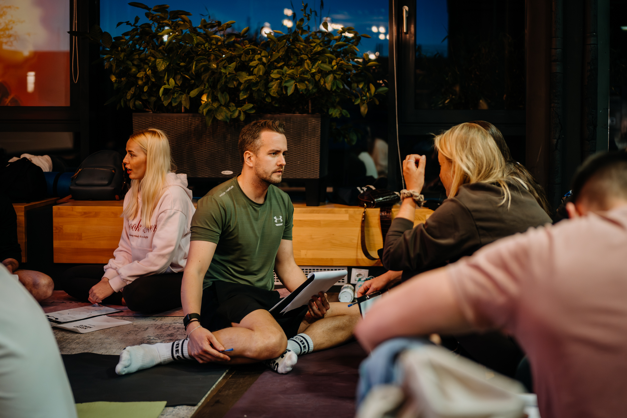 Guided meditation with participants lying down in a dimly lit room