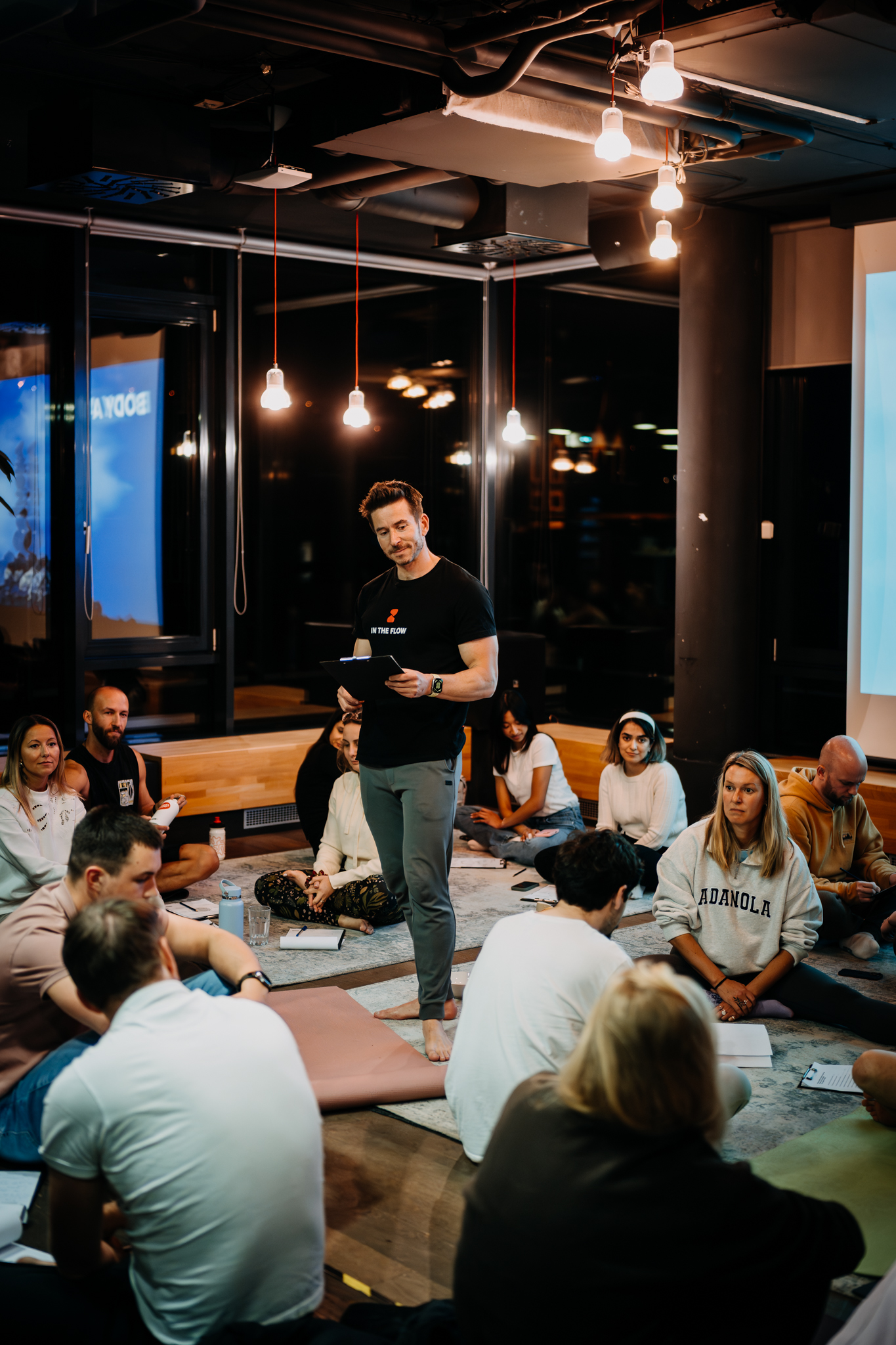 Two participants in intimate conversation on yoga mats