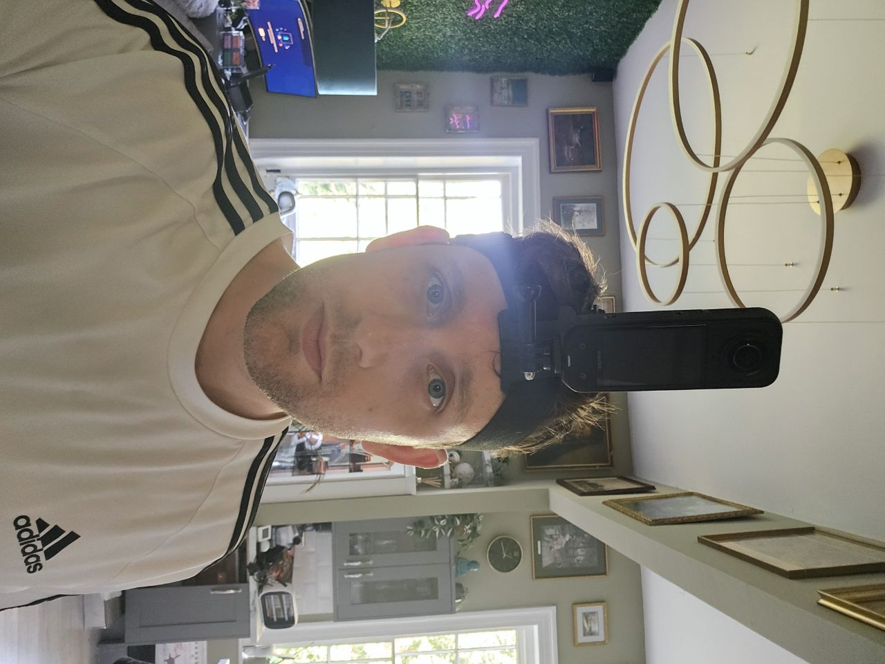 Front view of the Insta360 X5 mounted on a head strap near the left eye